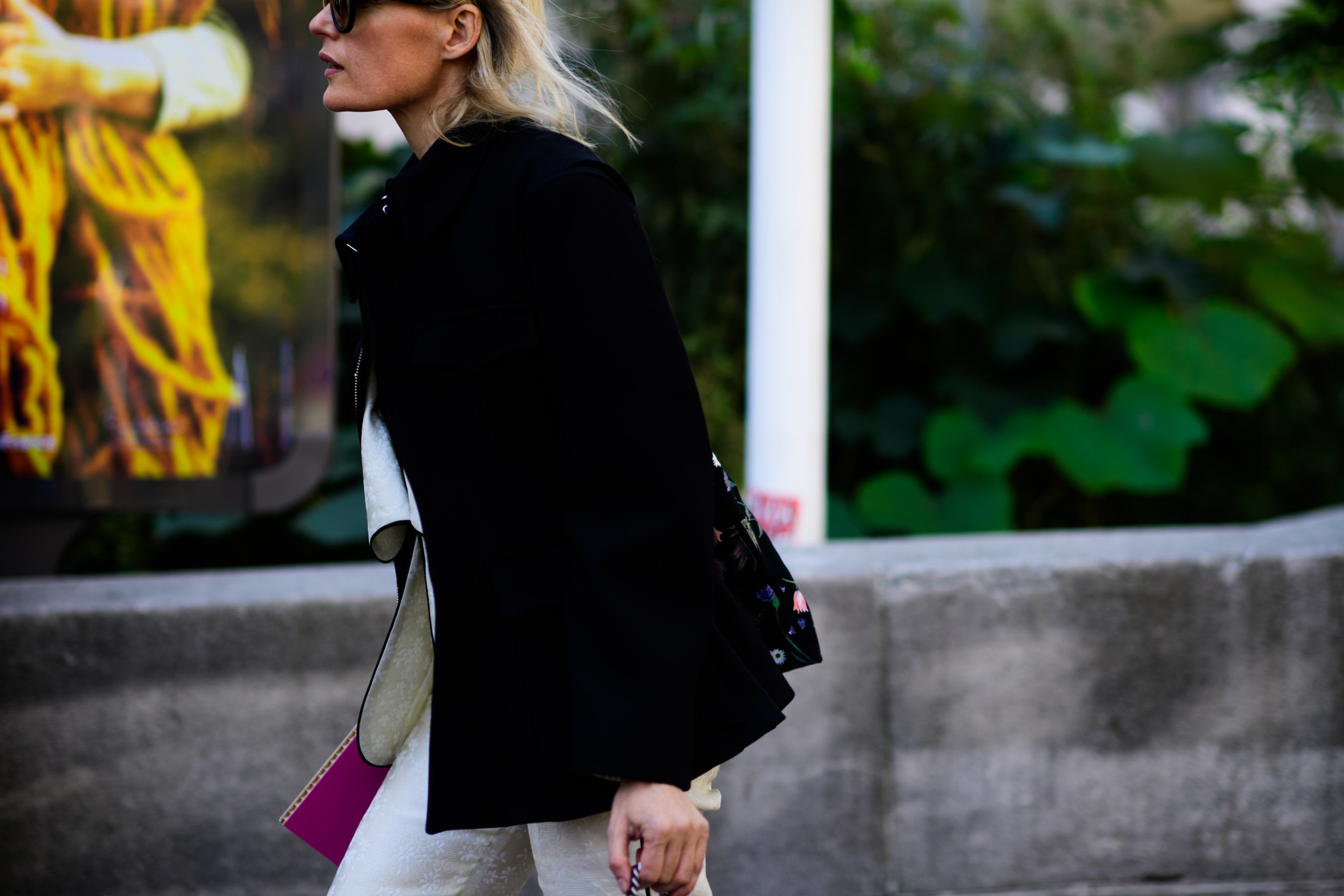 Woman in black jacket and white jeans