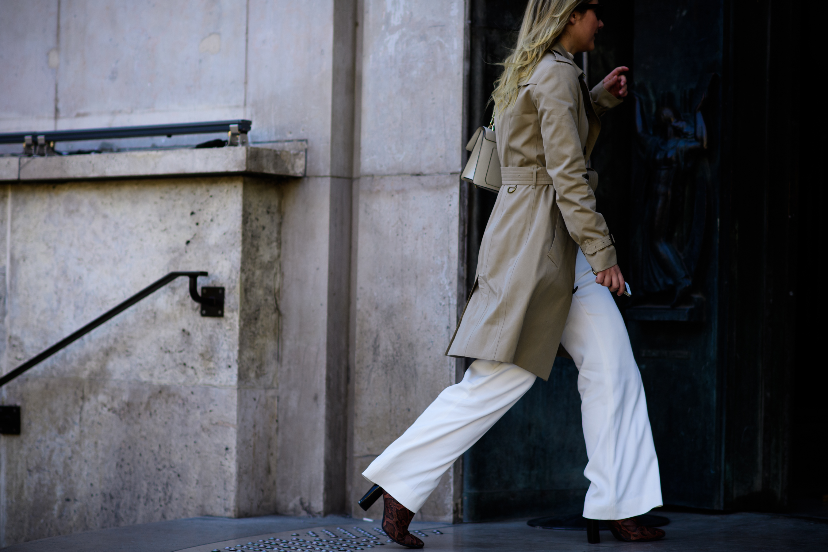 Woman in camel trench coat