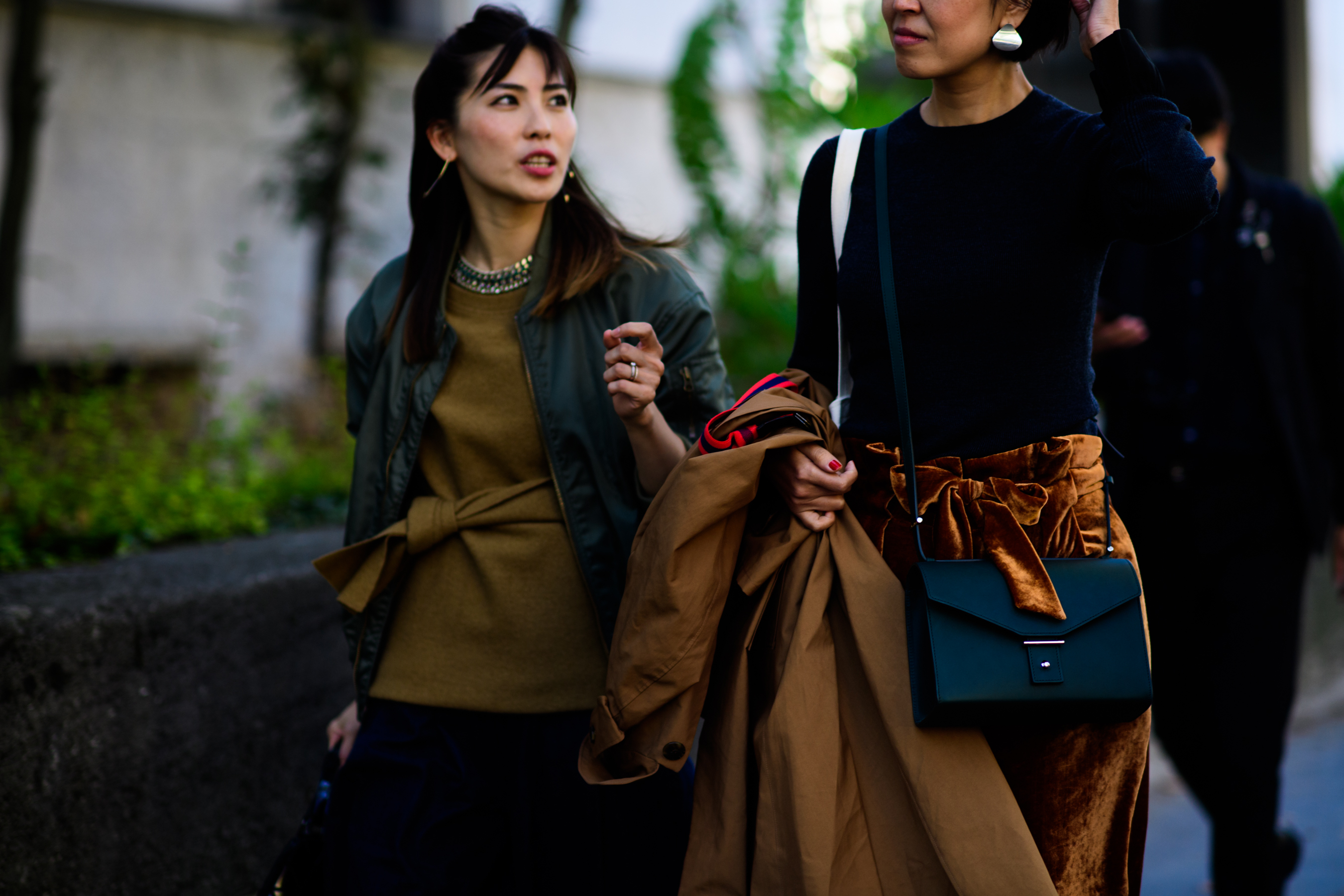 Two women wearing green and brown
