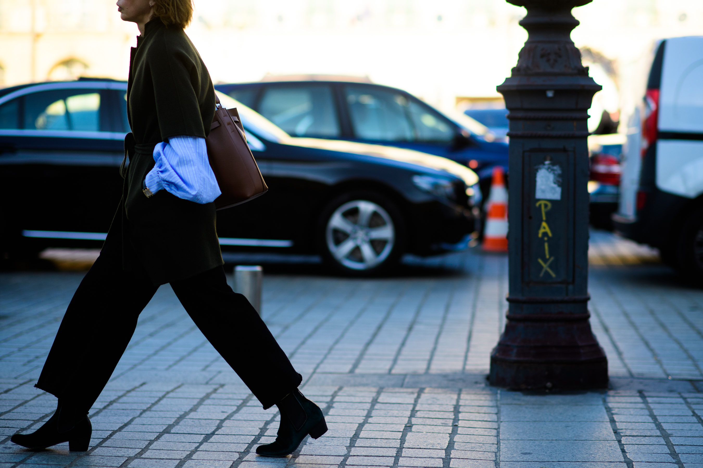 Side of woman walking in green wool jumper