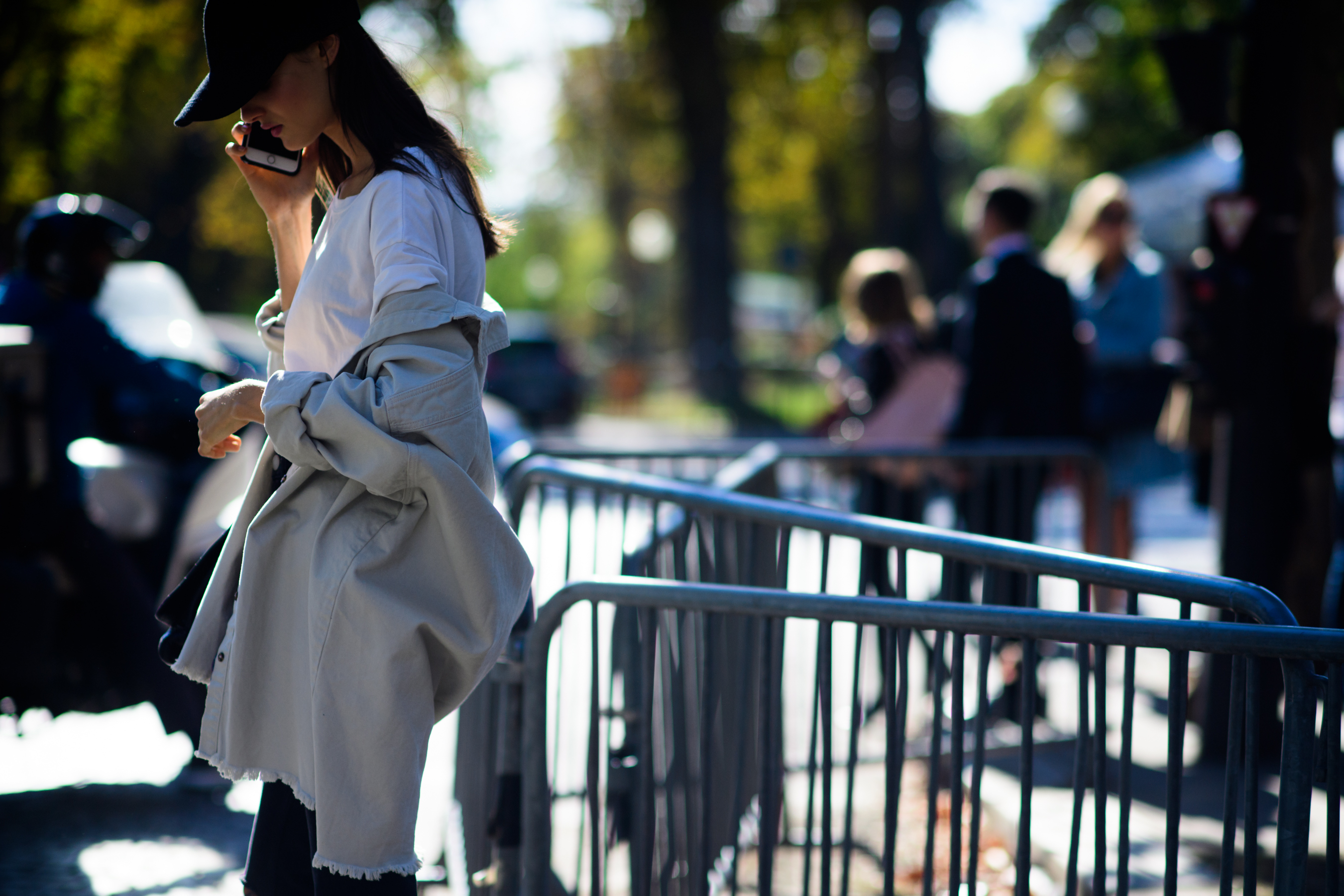 Model talking on phone with black cap