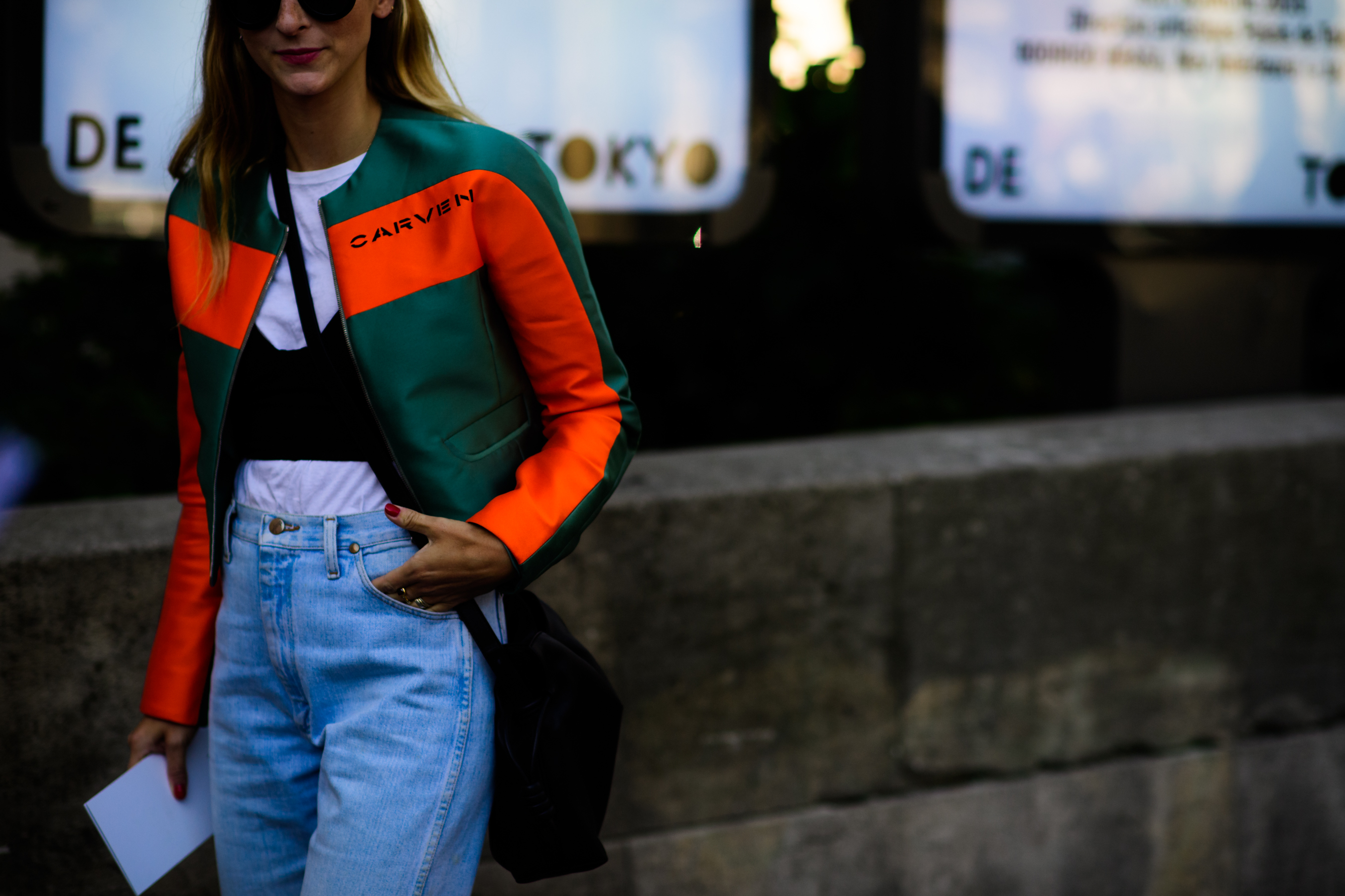 Director wearing green and orange jacket