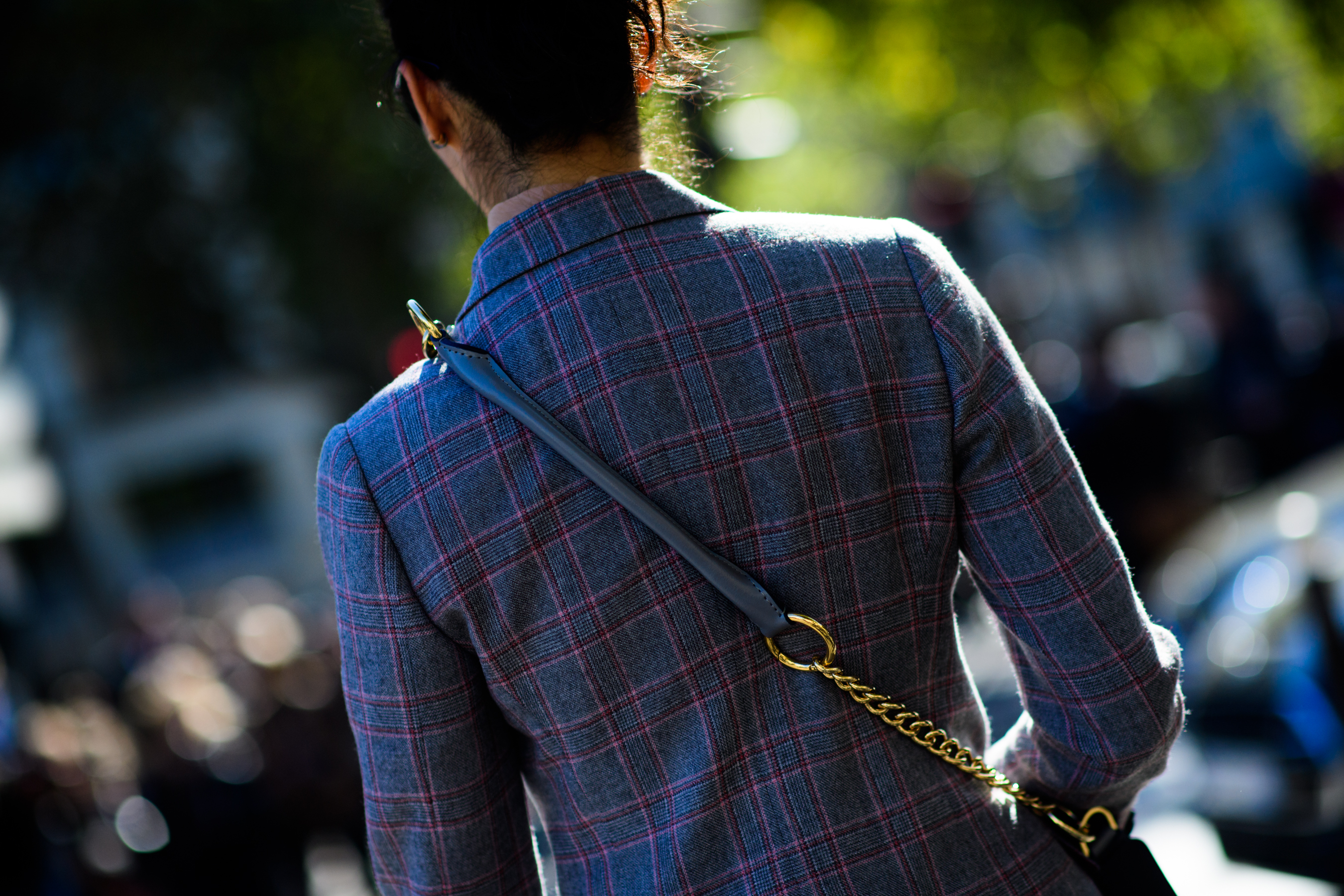 Back of woman in red and grey check suit