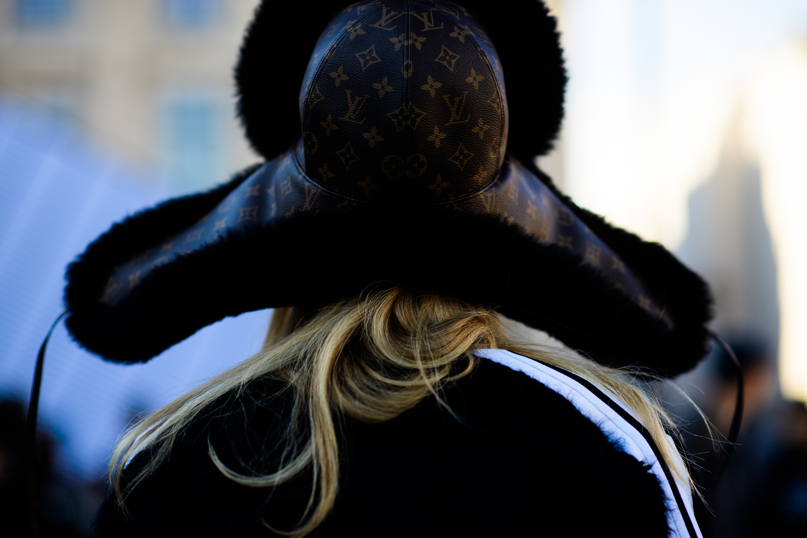 Closeup of back of bloggers head in trapper hat
