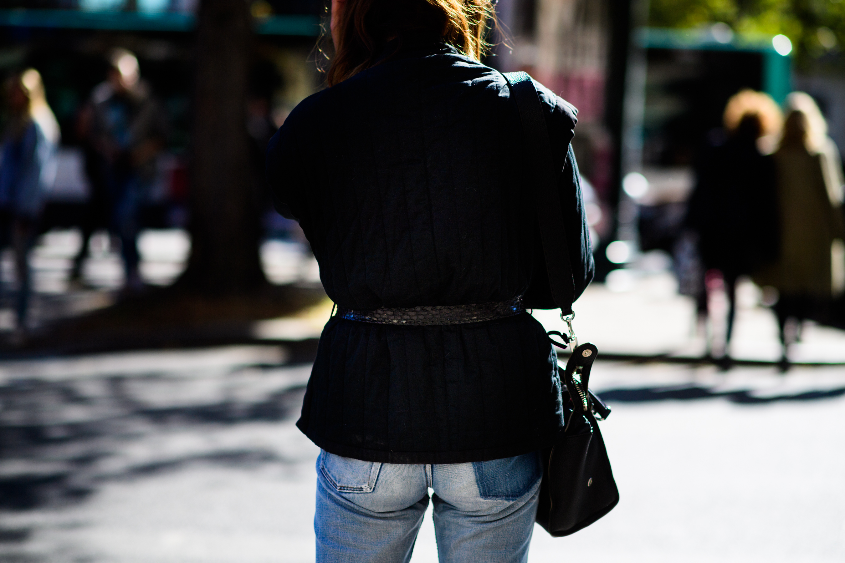 Back of woman in black jacket