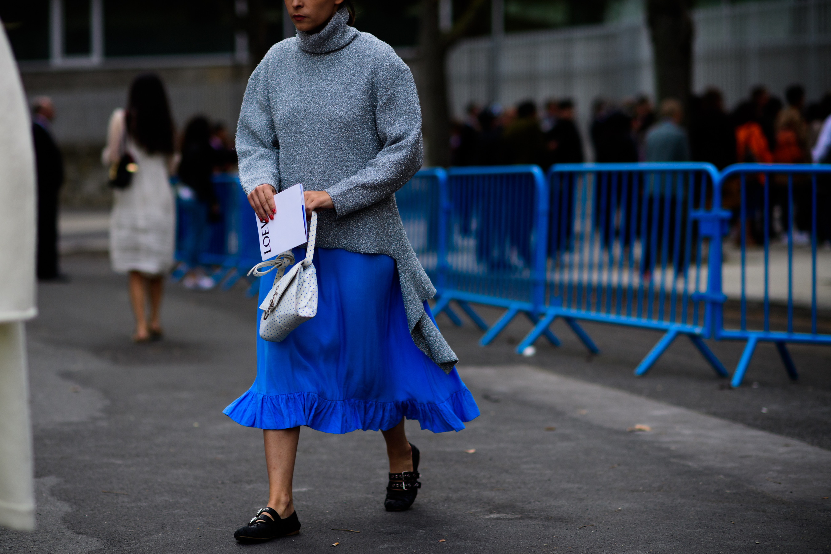 Buyer walking in blue skirt and grey jumper