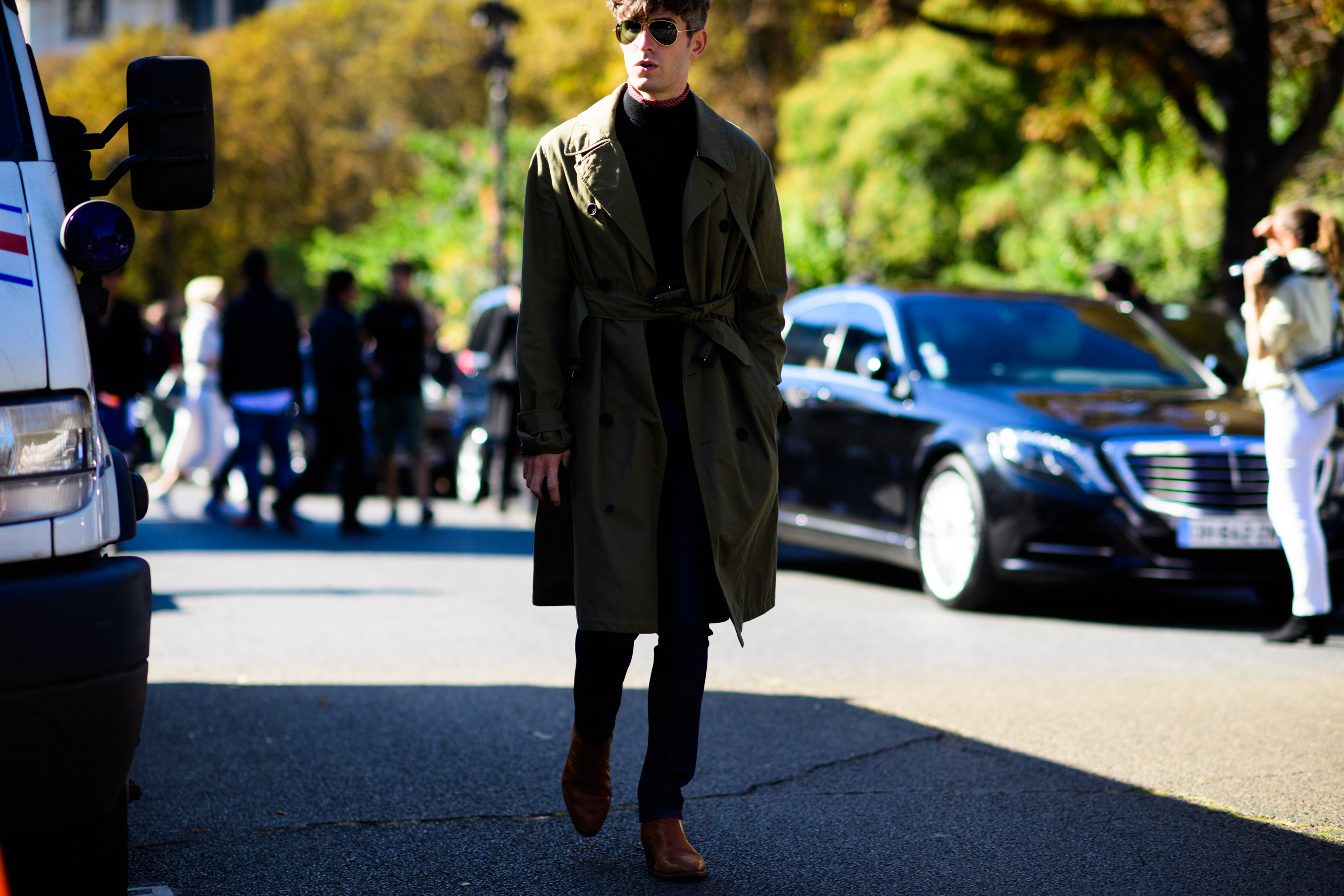 Man walking in green trench coat