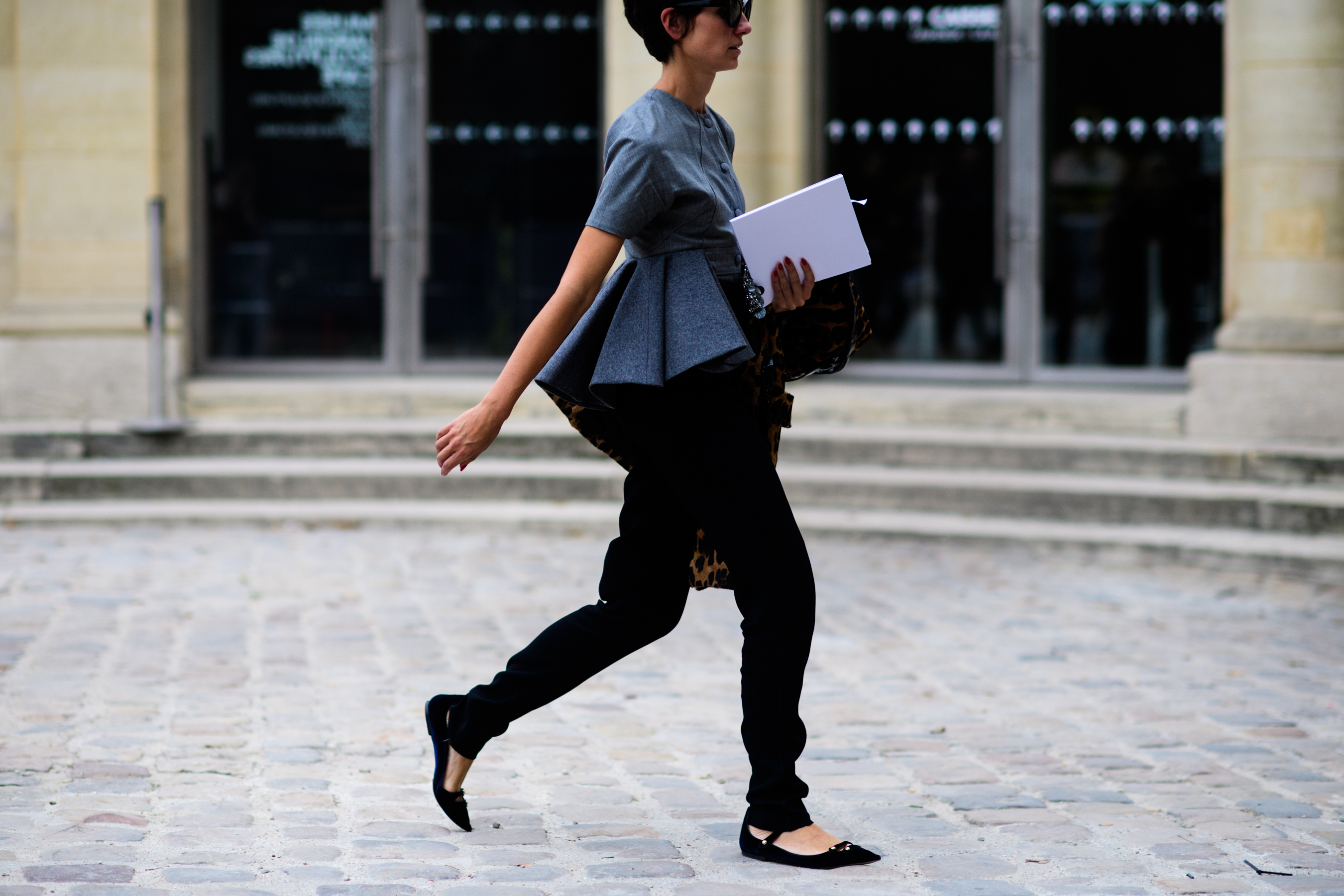 Editor wearing grey pleated top