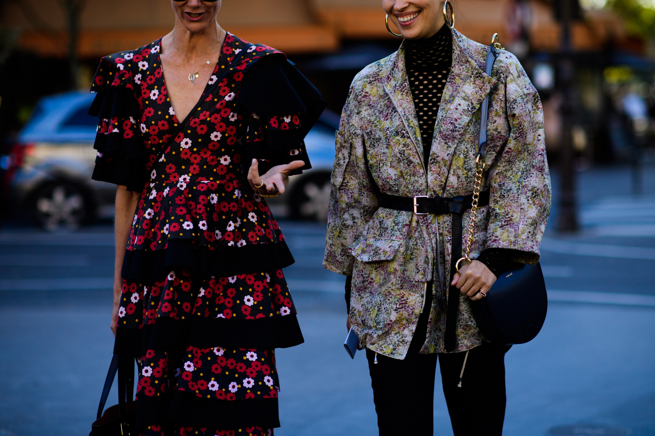 Two women wearing floral design outfits