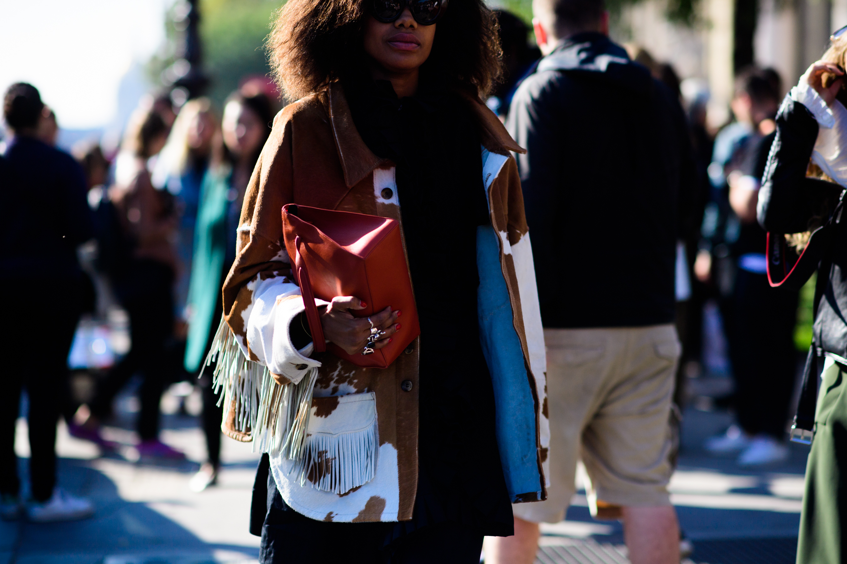 Fashion director holding red bag