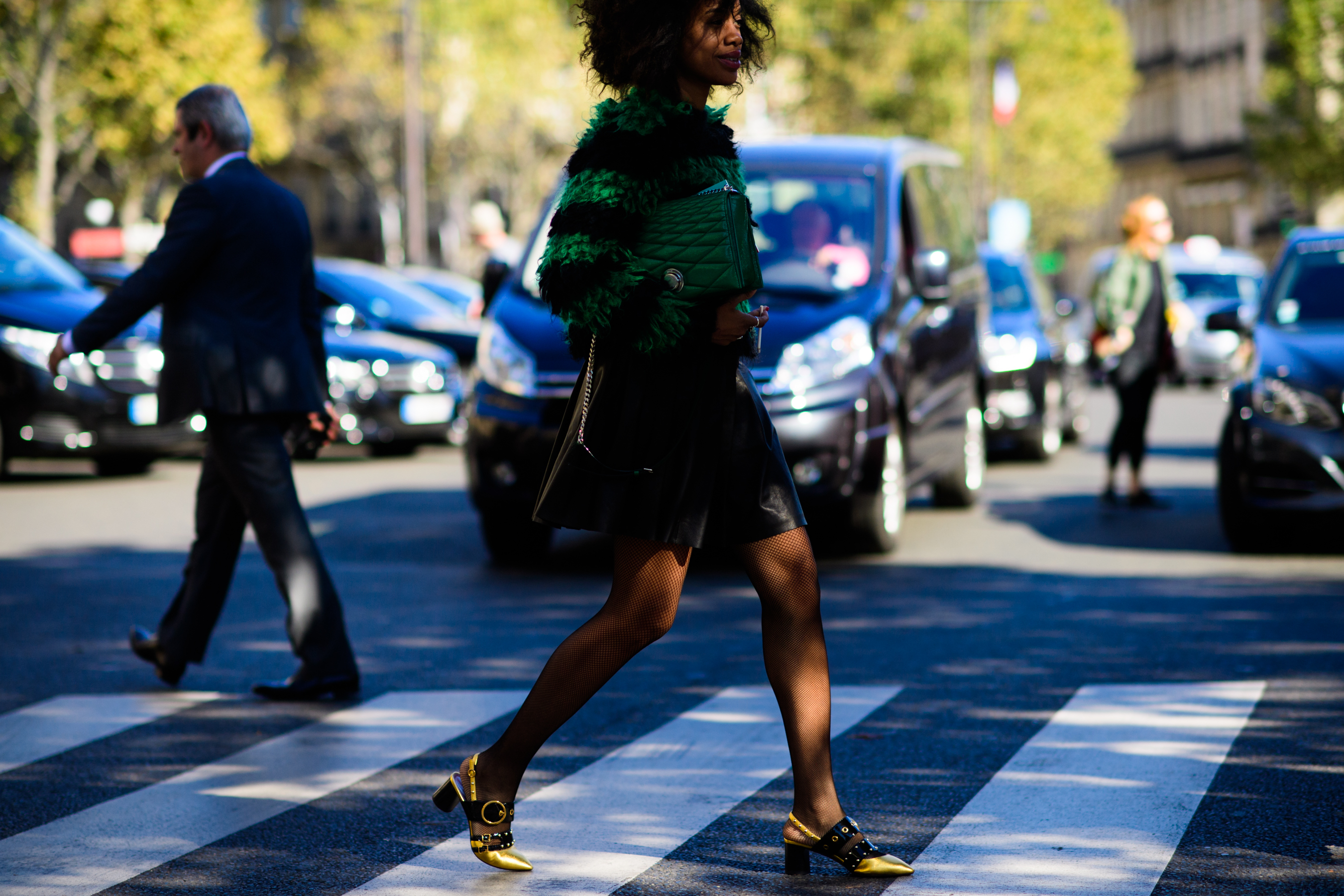 Editor crossing road in green jumper