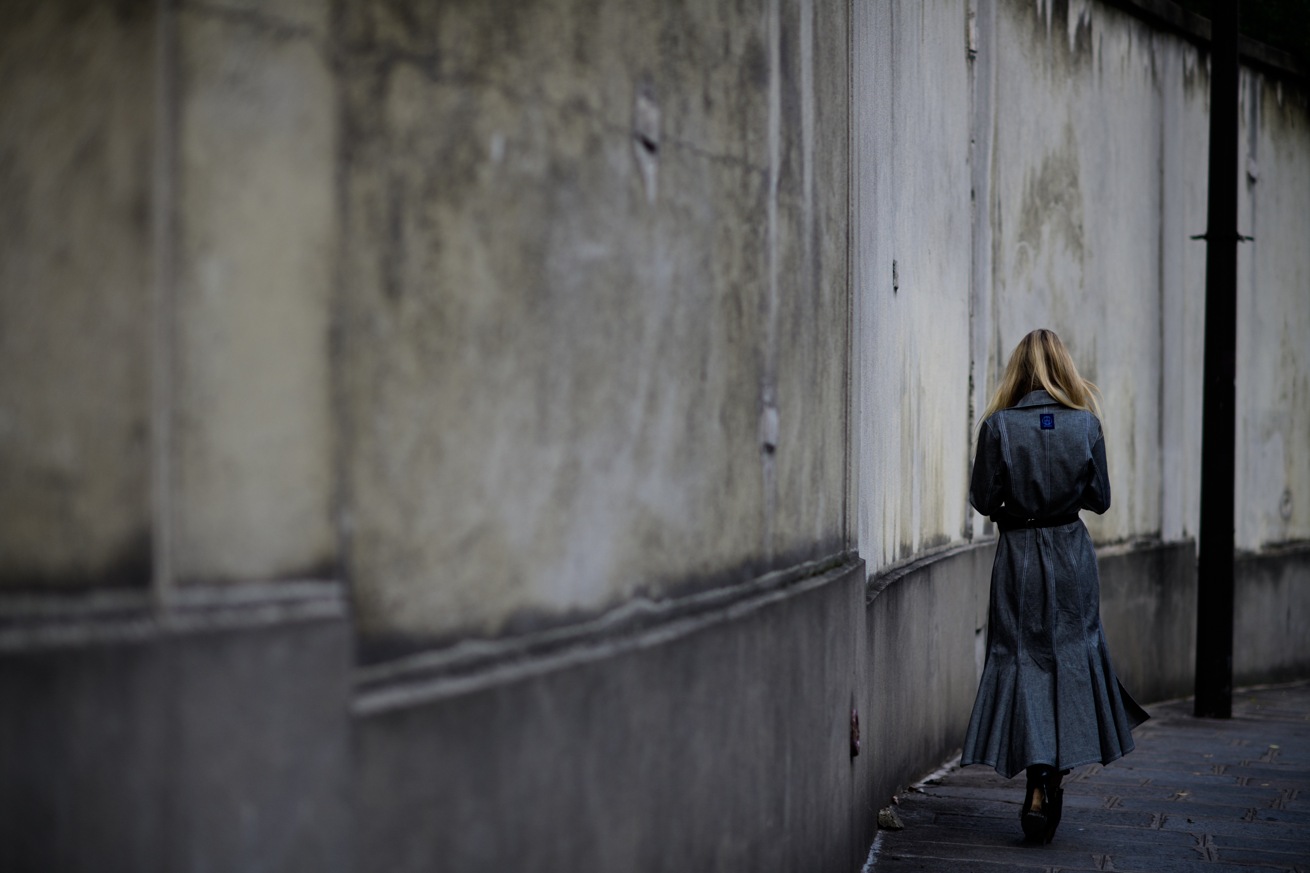 Wide shot of Danish editor walking in grey dress