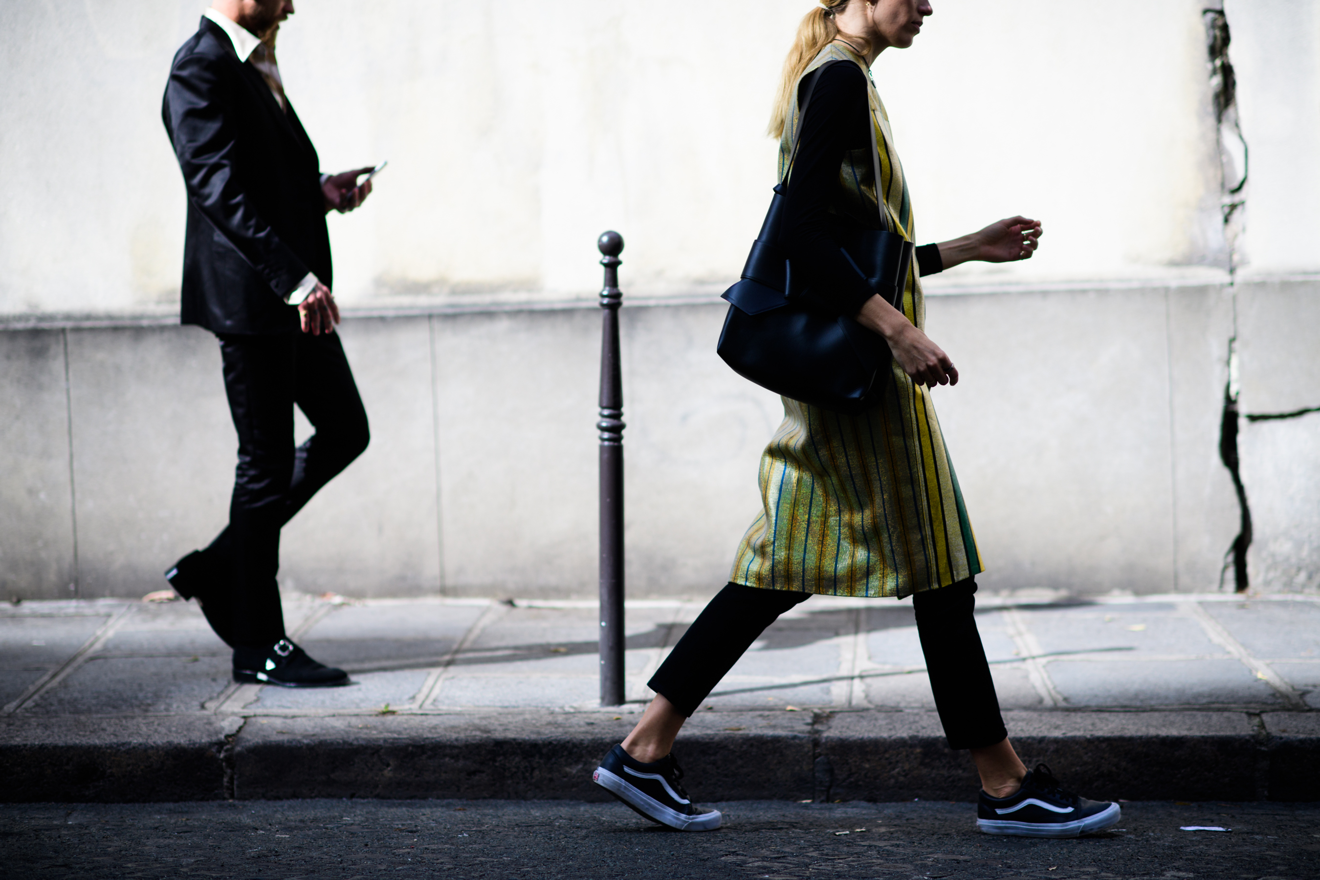 Australian buyer and German model walking parallel to wall