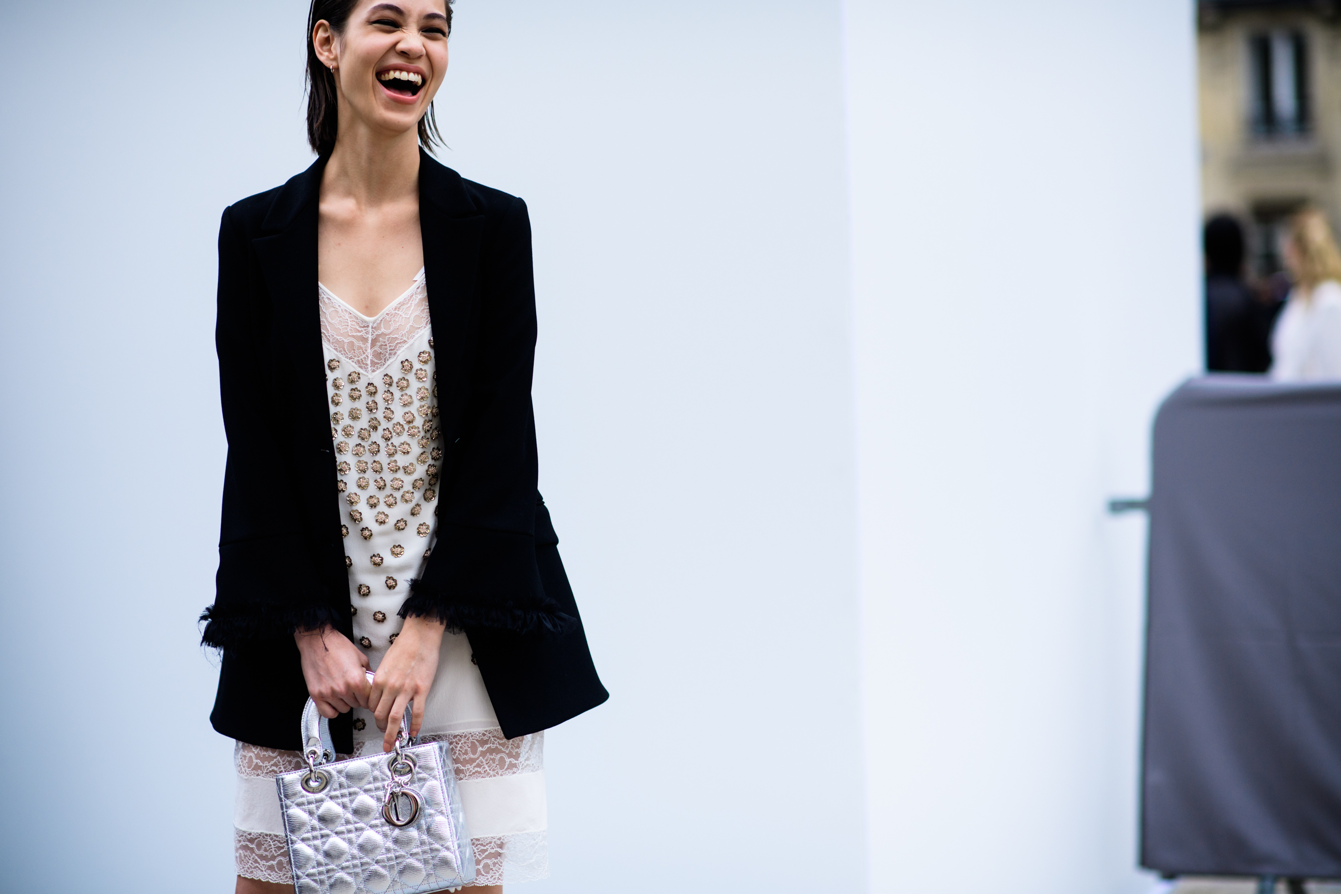 Japanese model laughing and holding silver bag