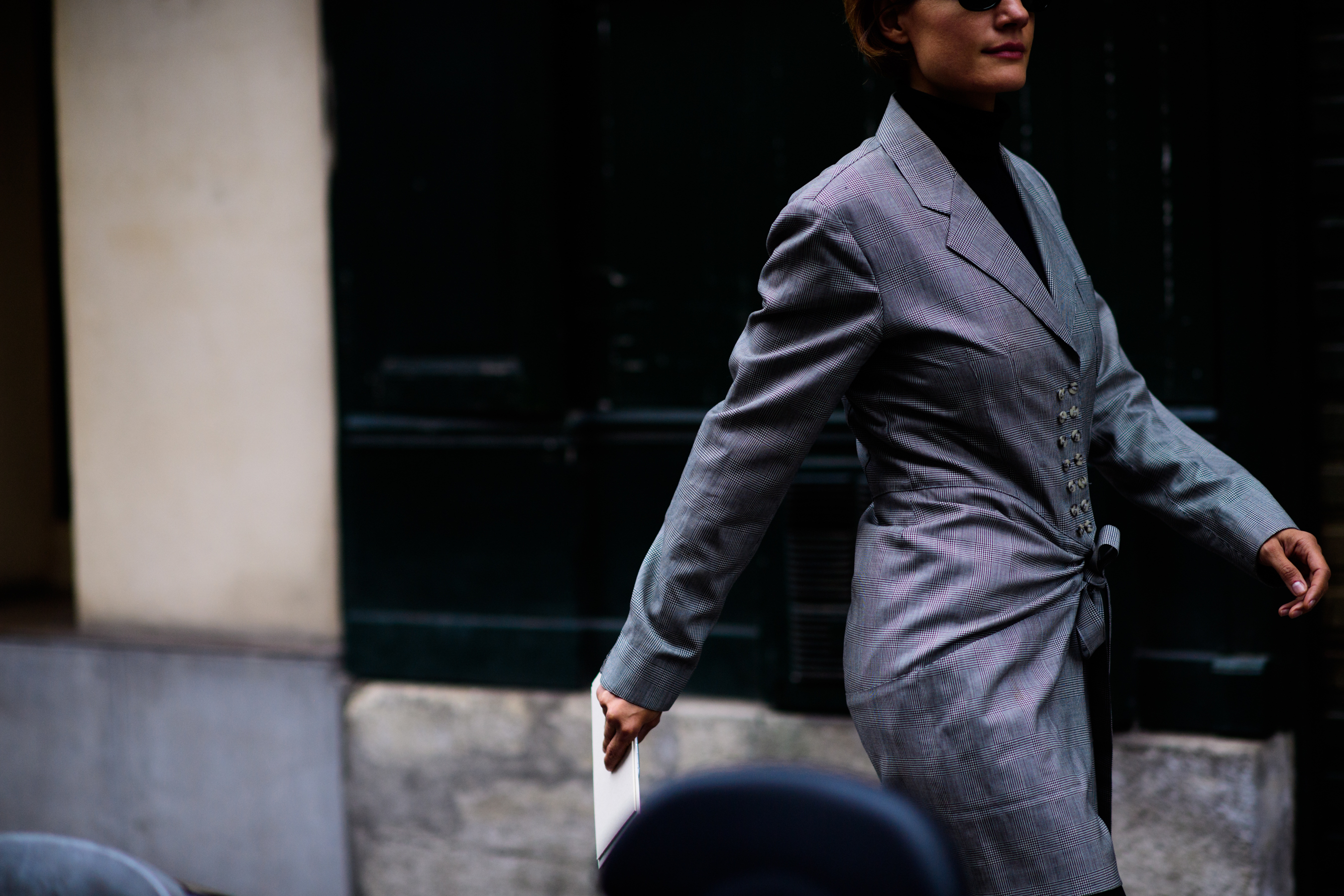 Editor wearing long grey check jacket