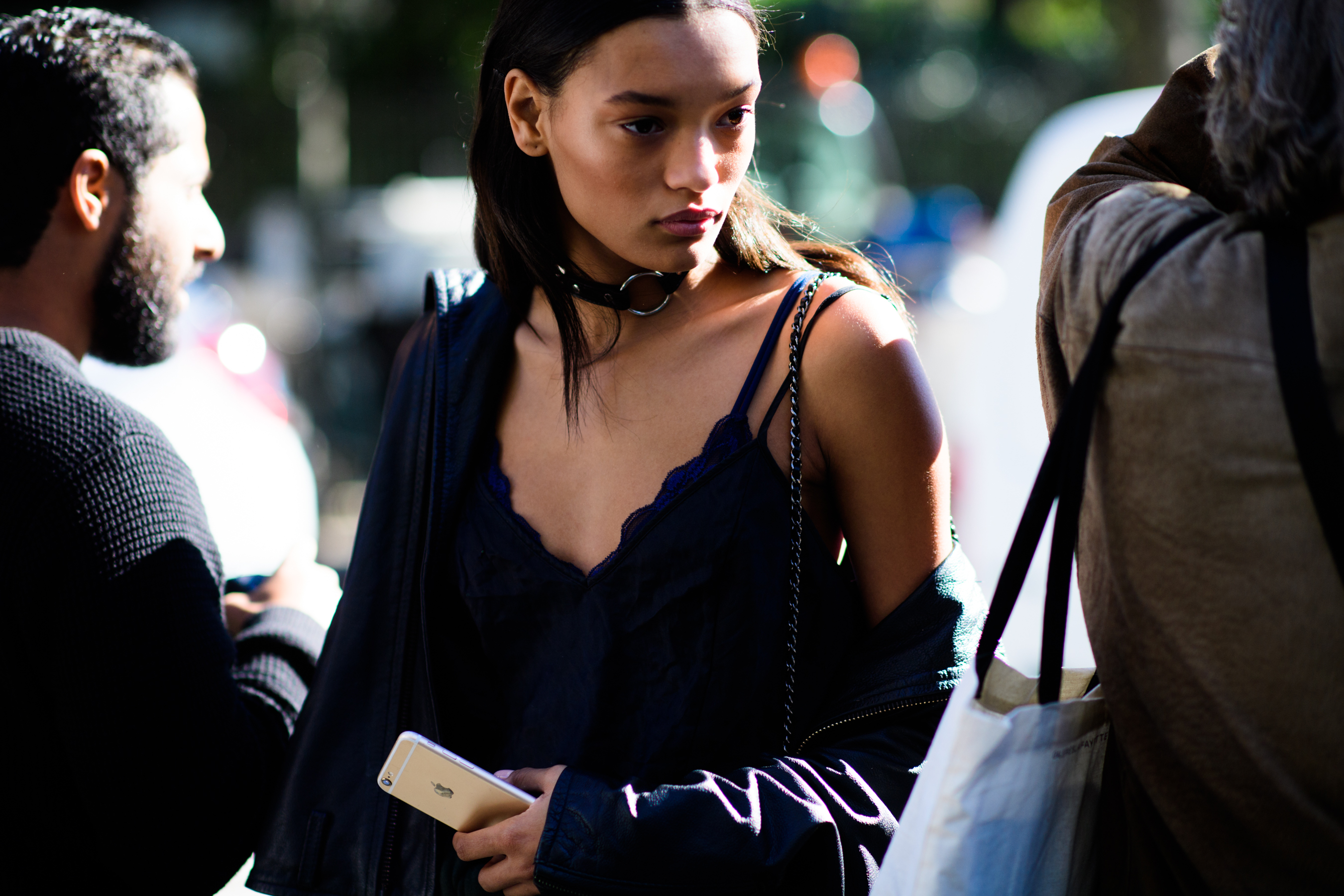 American model wearing black choker
