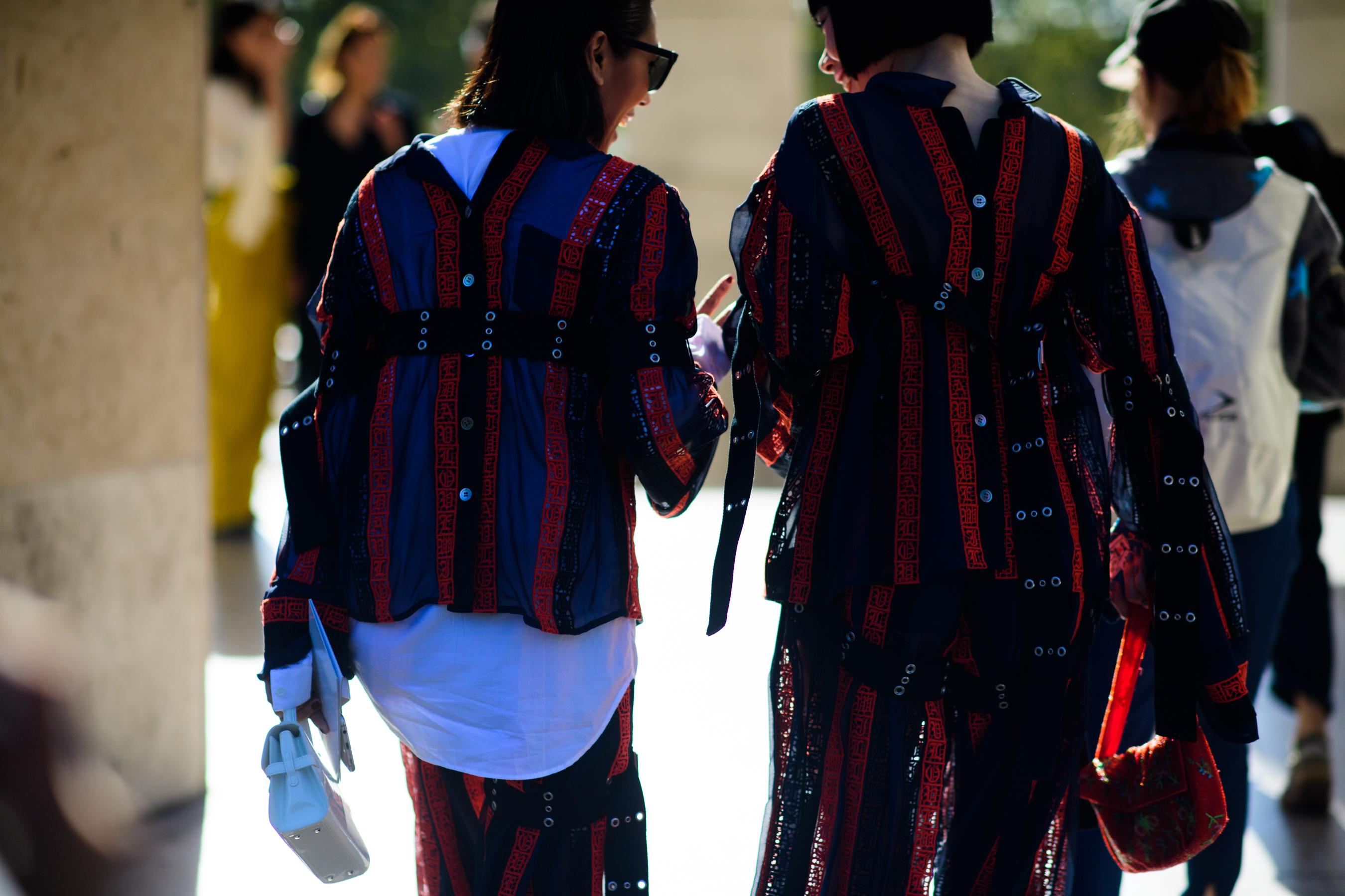 Two women wearing matching patterned shirts