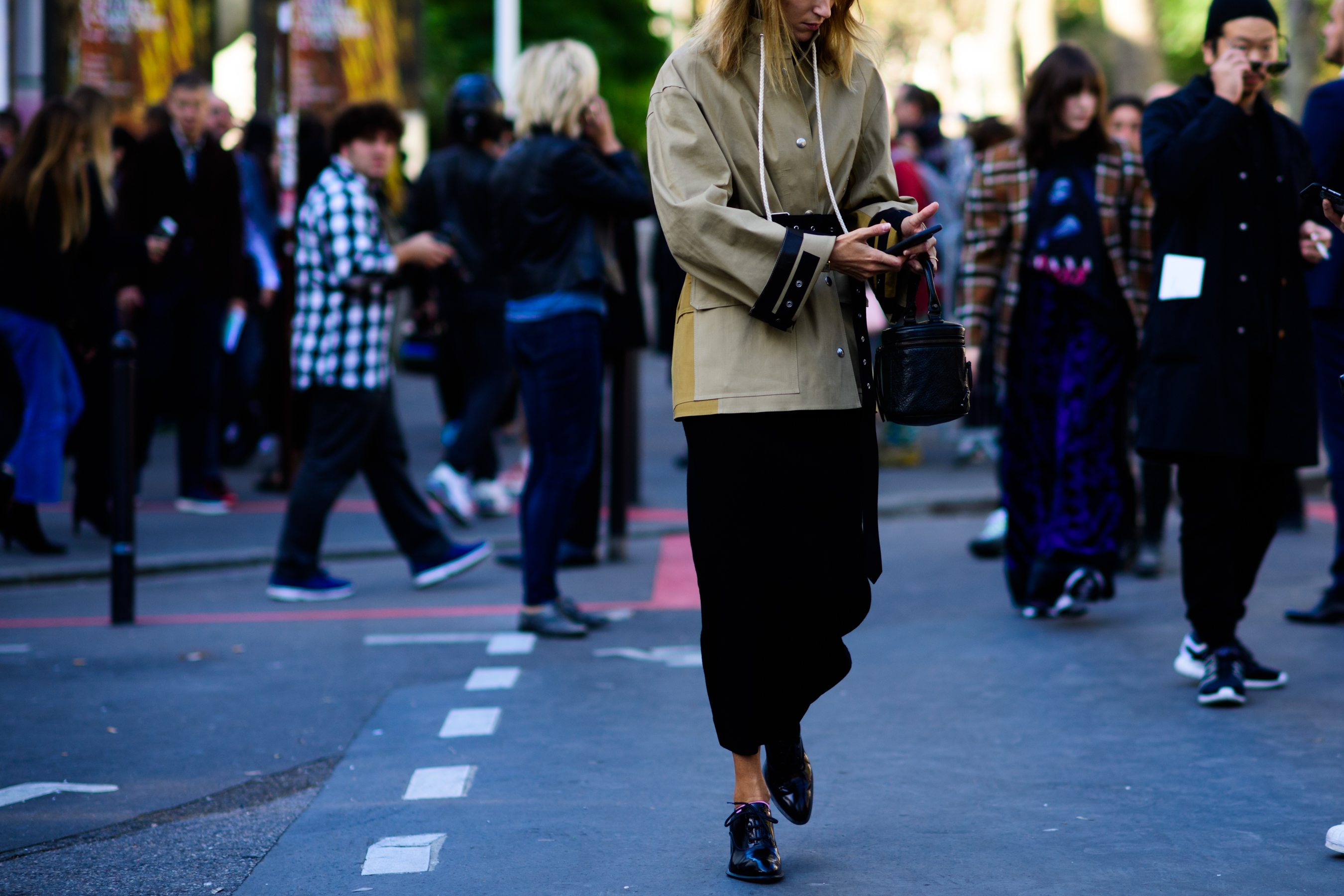 Style director wearing green coat and black pants