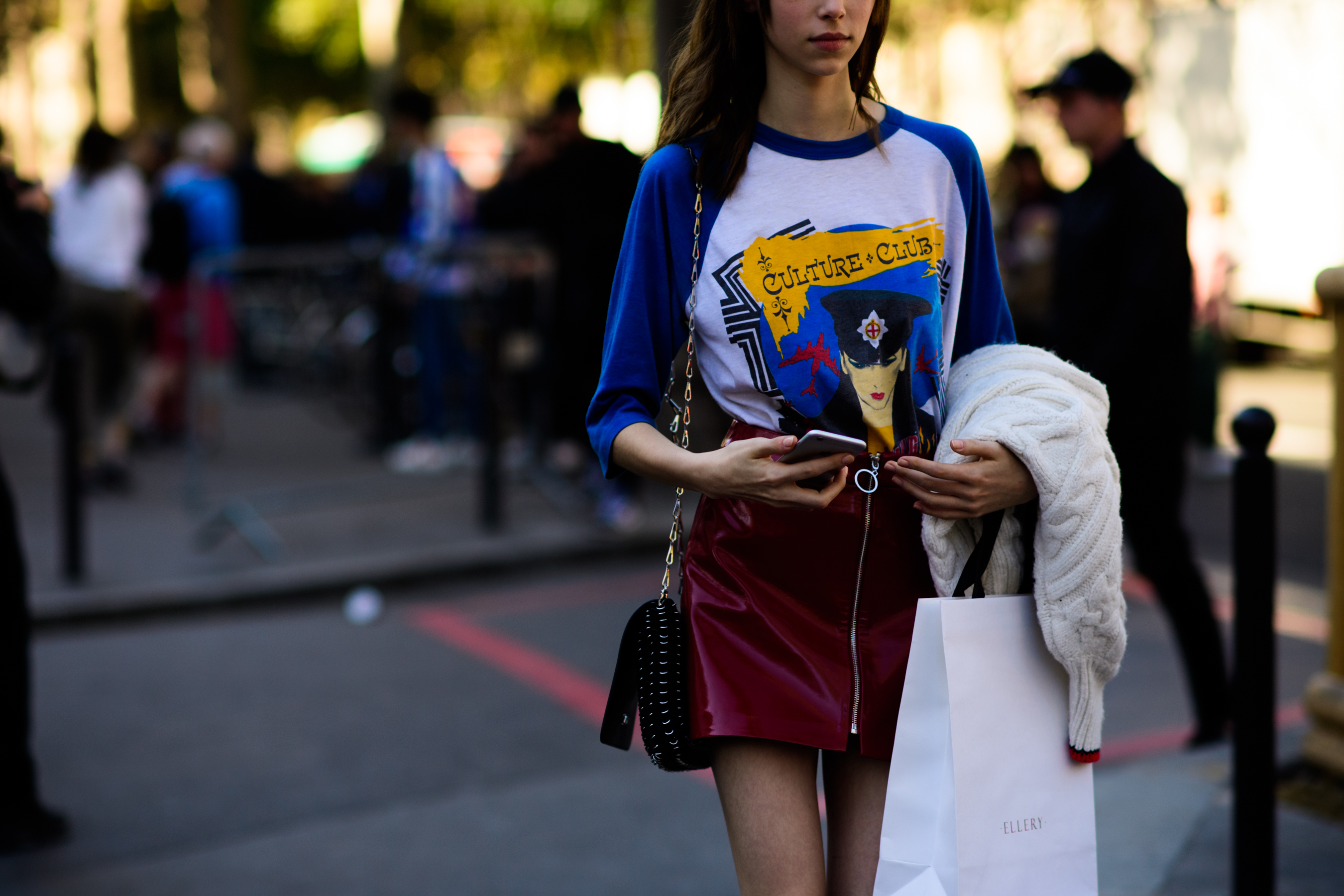 Model wearing blue and white graphic tee shirt