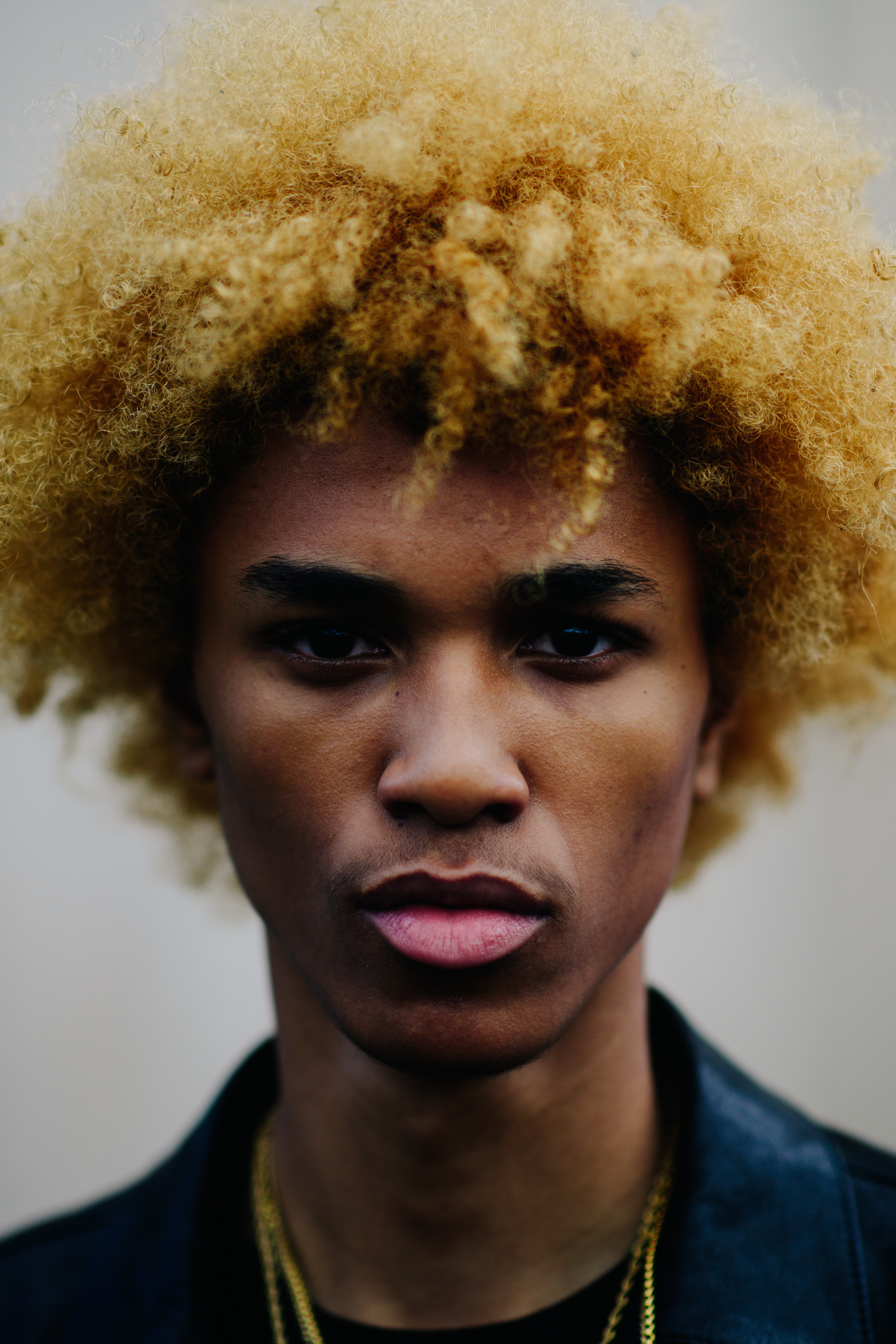 Portrait of American male model with blonde afro