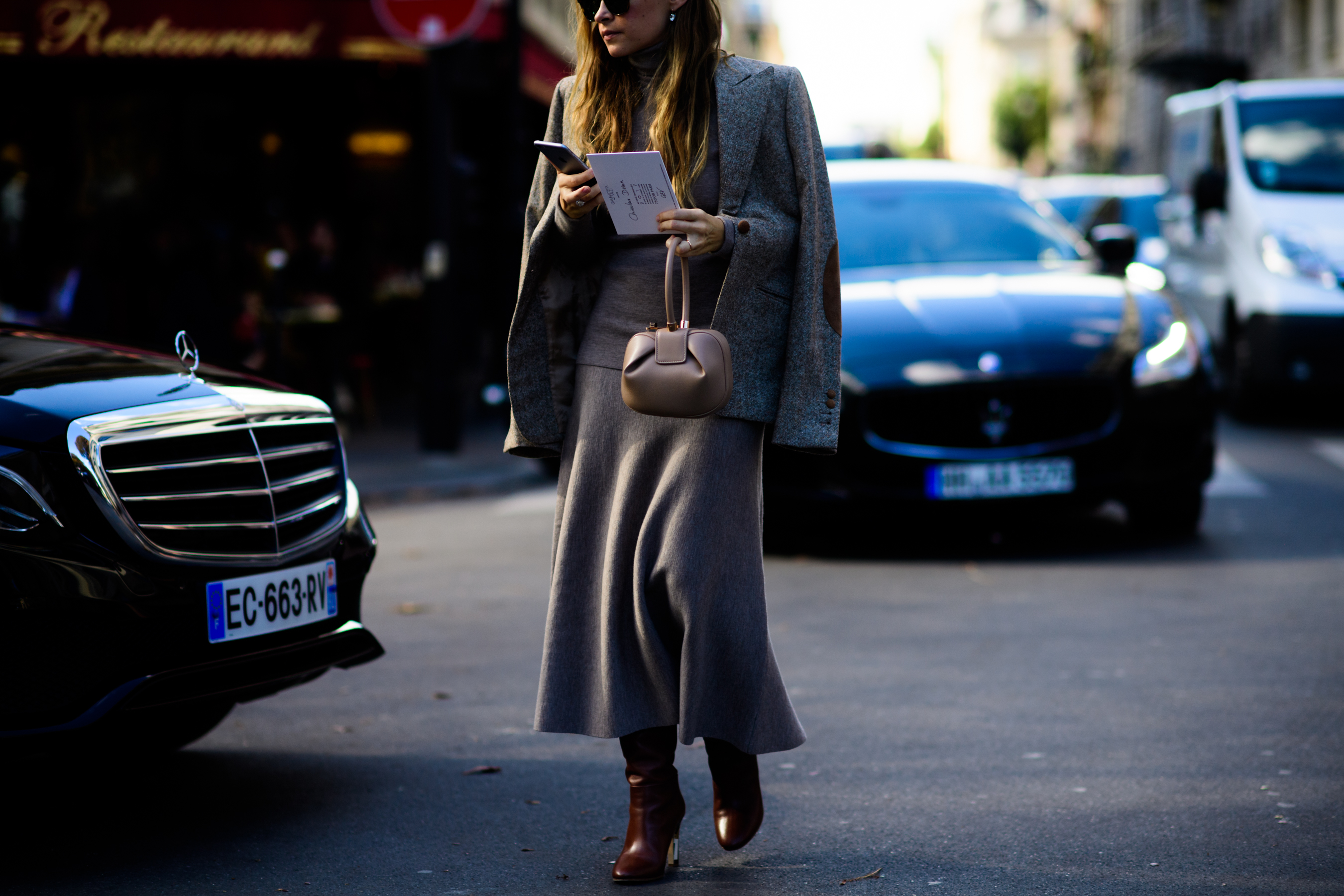 Russian editor wearing grey jacket and dress