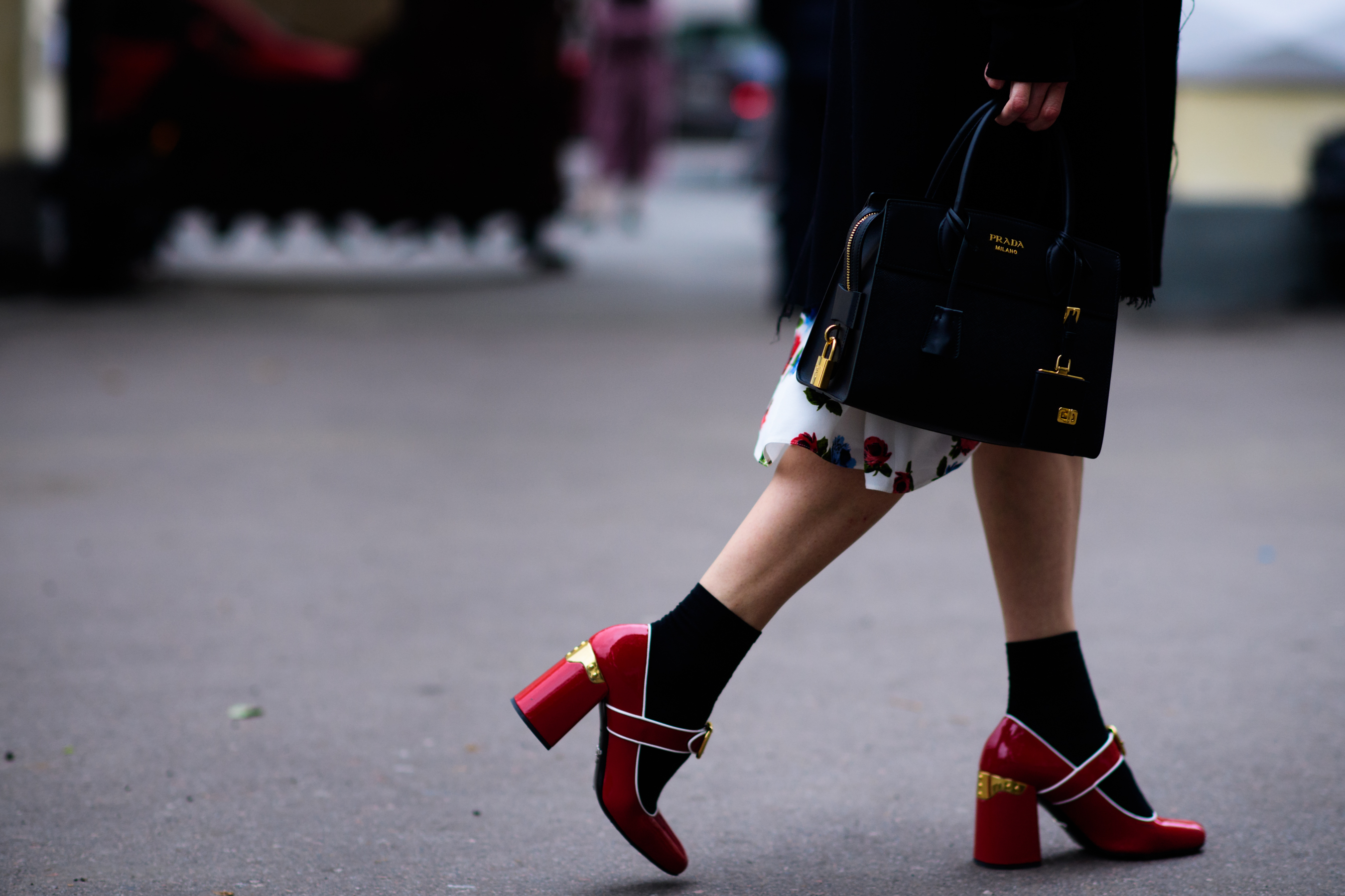 Woman wearing Prada shoes and bag