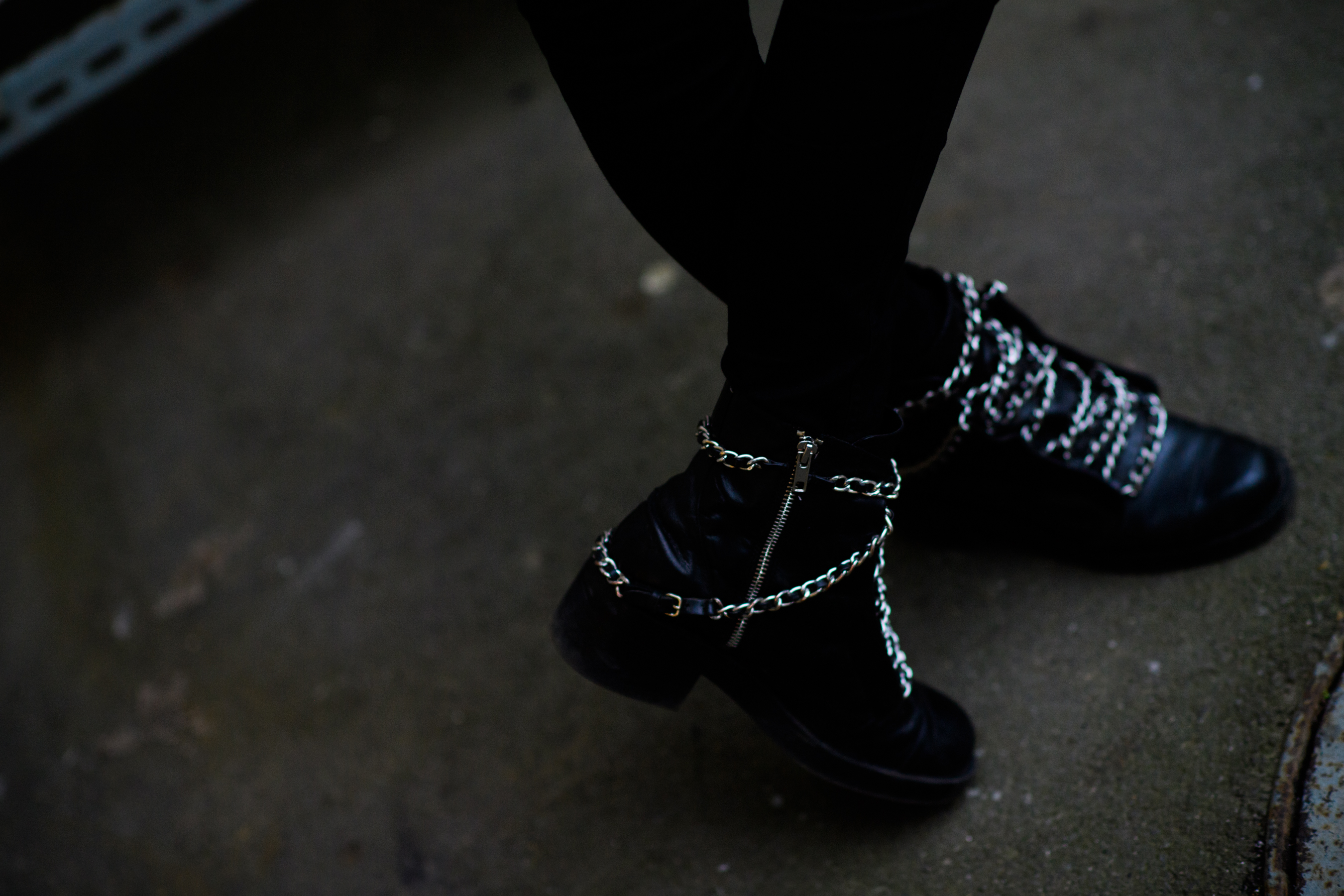 Girl wearing black boots with chains