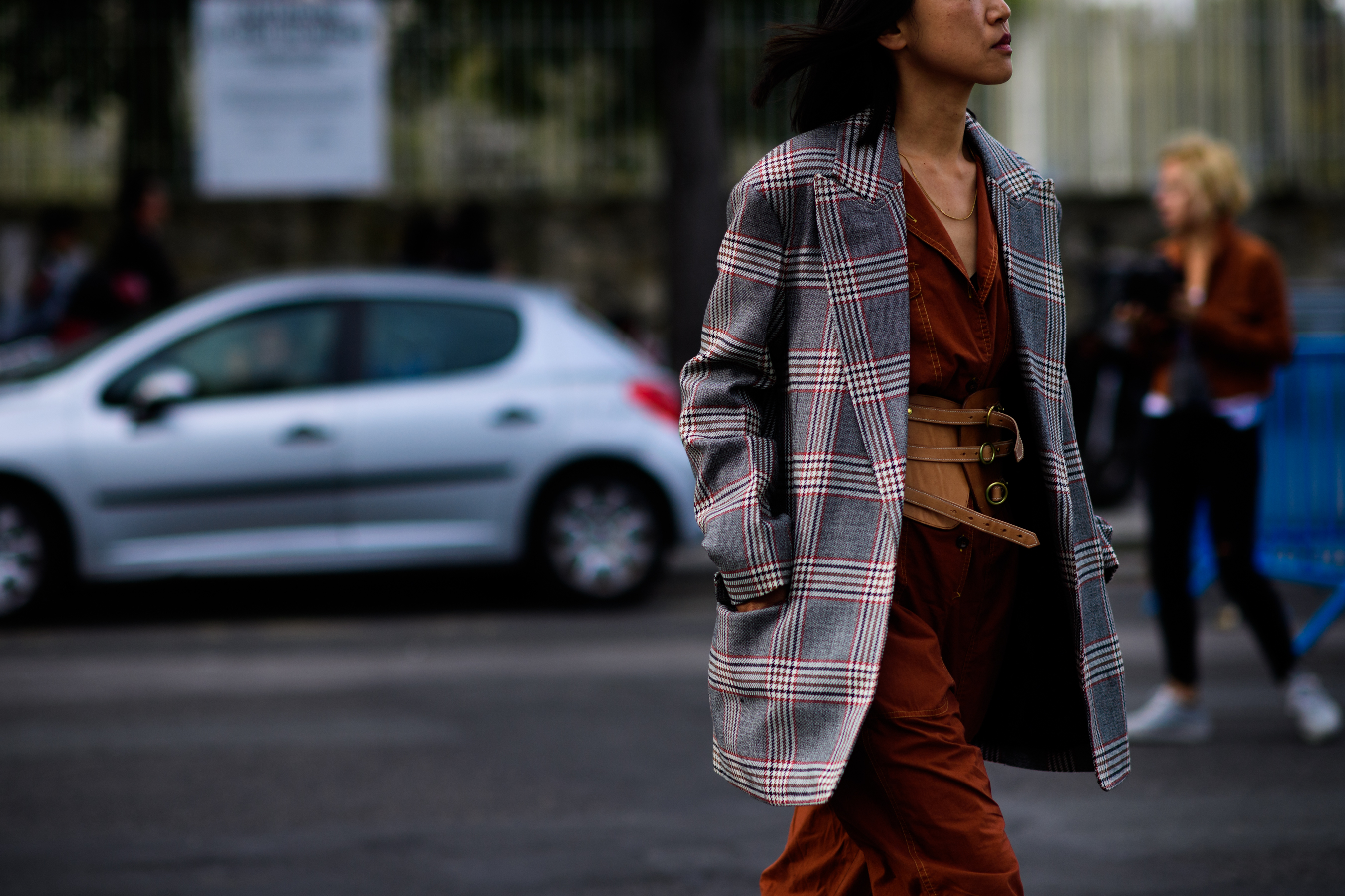 Woman wearing red check and brown leather belt