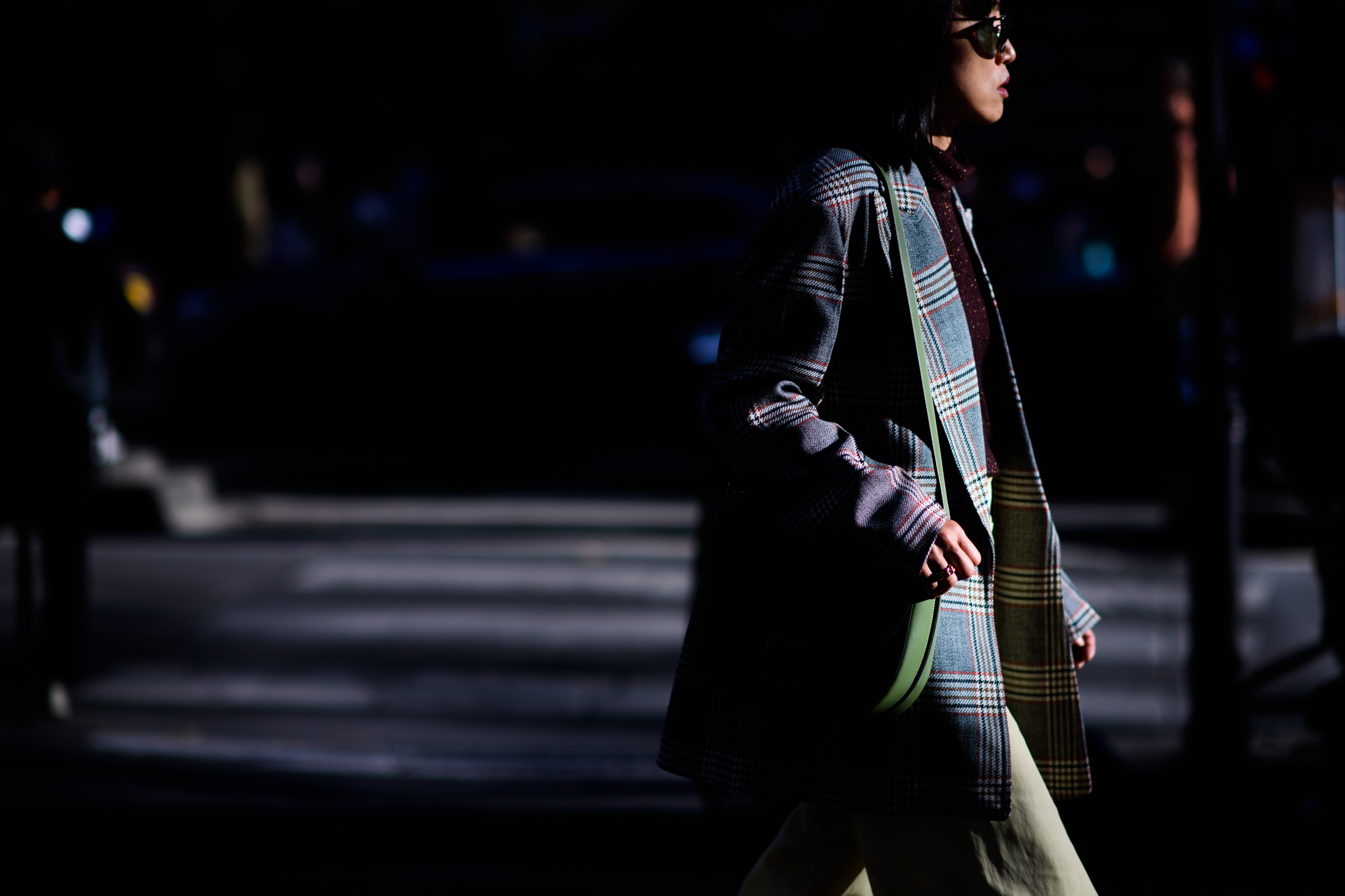 Japanese woman walking through dappled sunlight