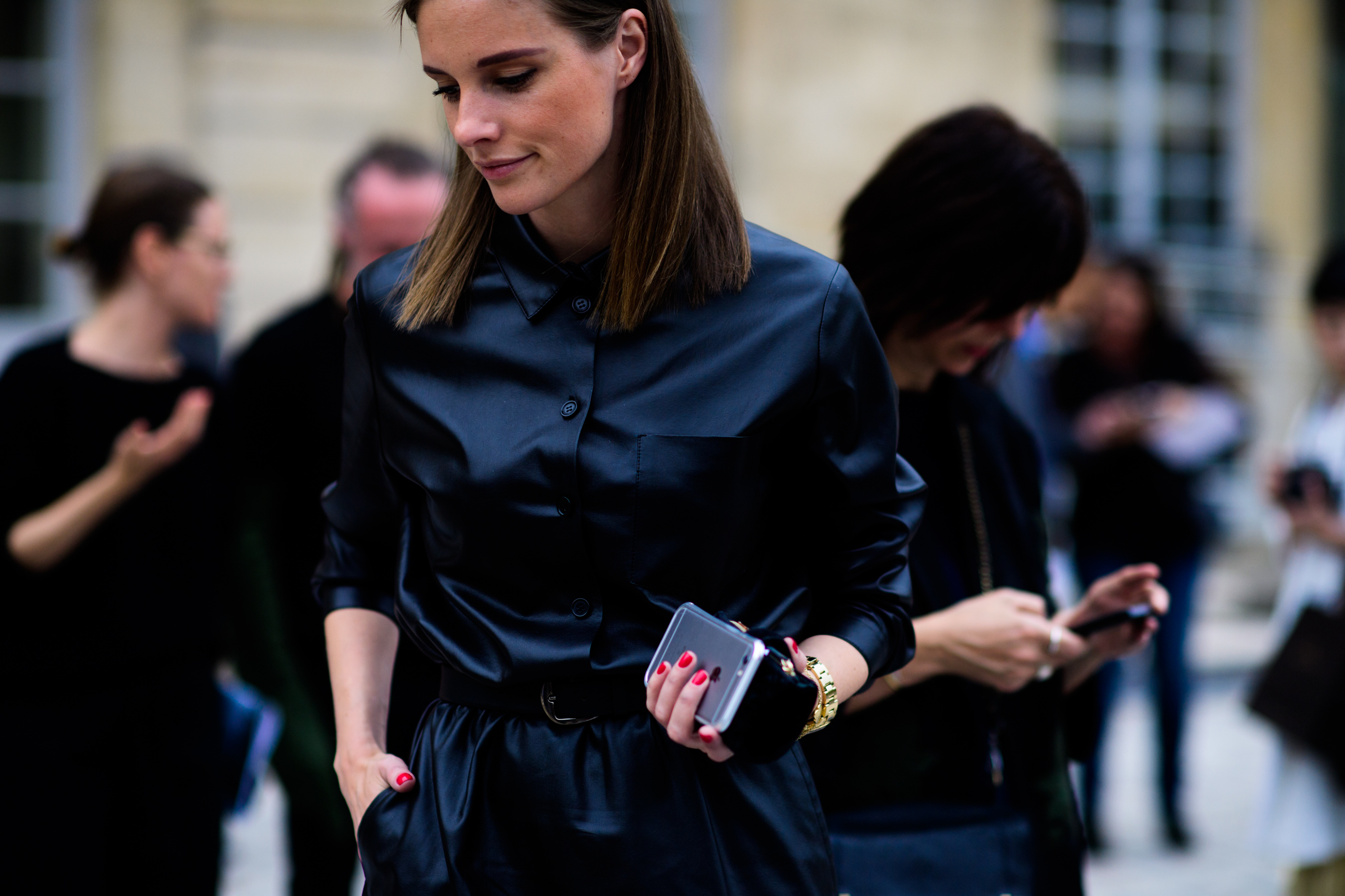 Woman in black shirt holding phone
