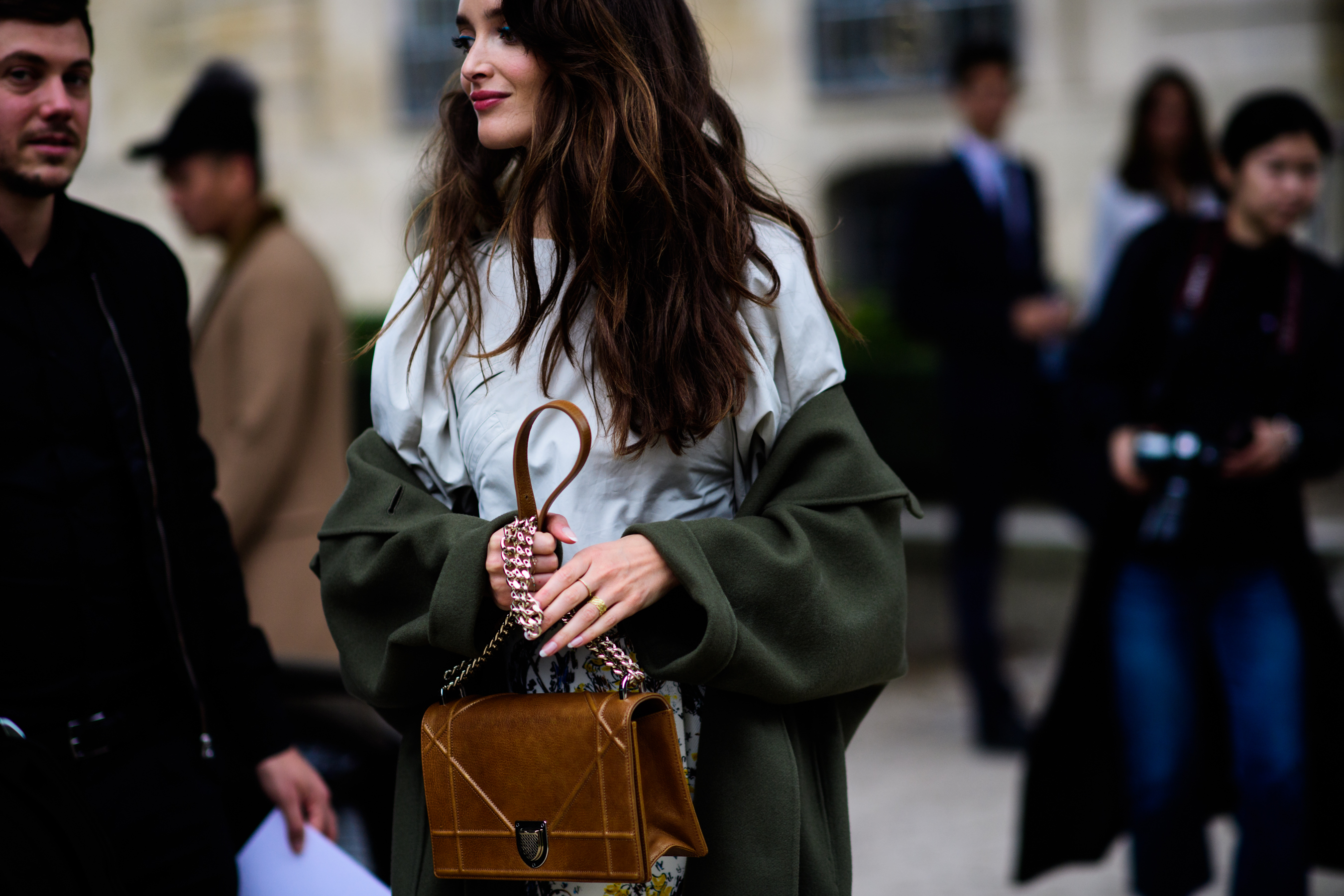 Woman with green coat around arms