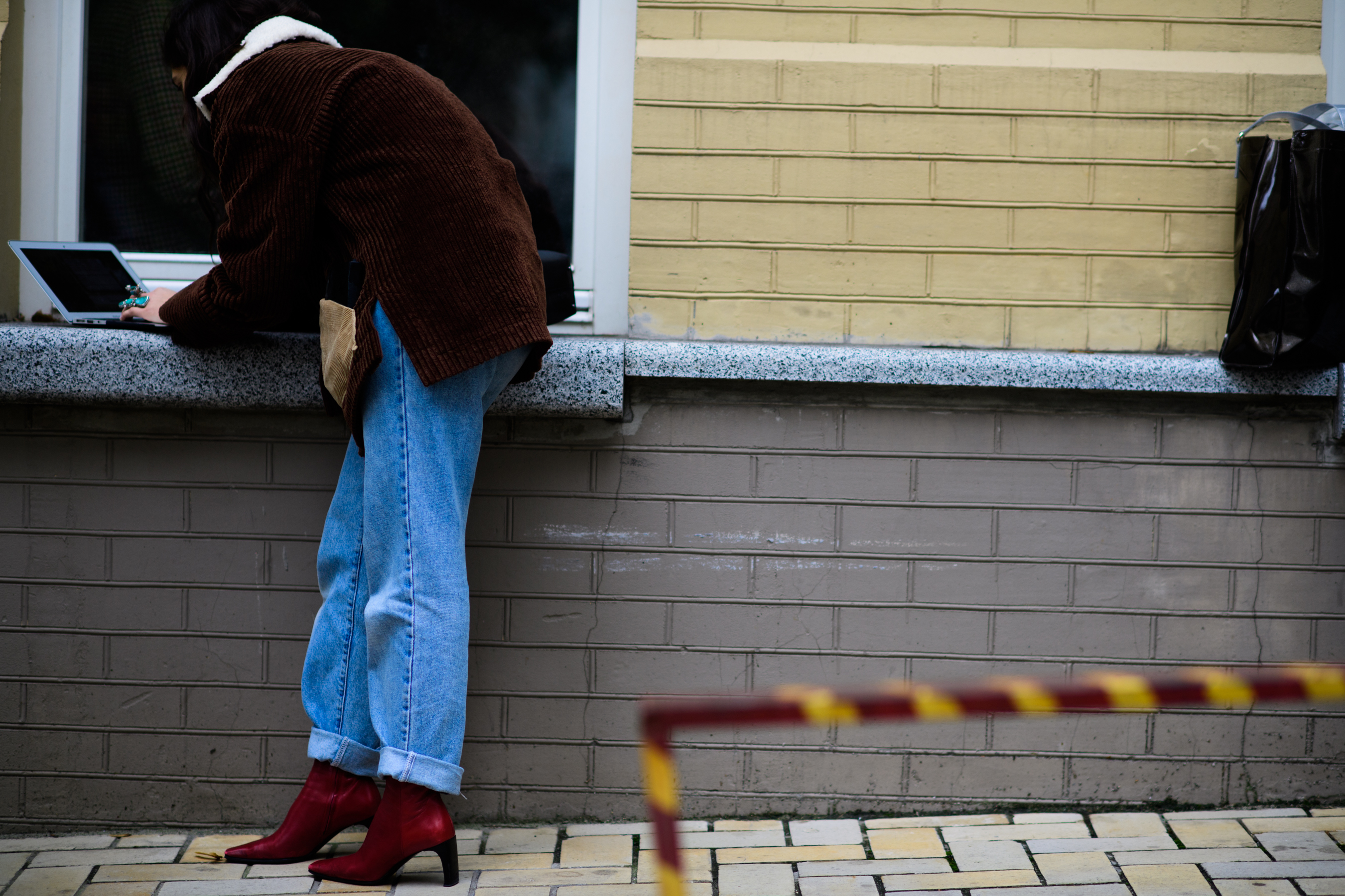 Woman wearing red boots and denim