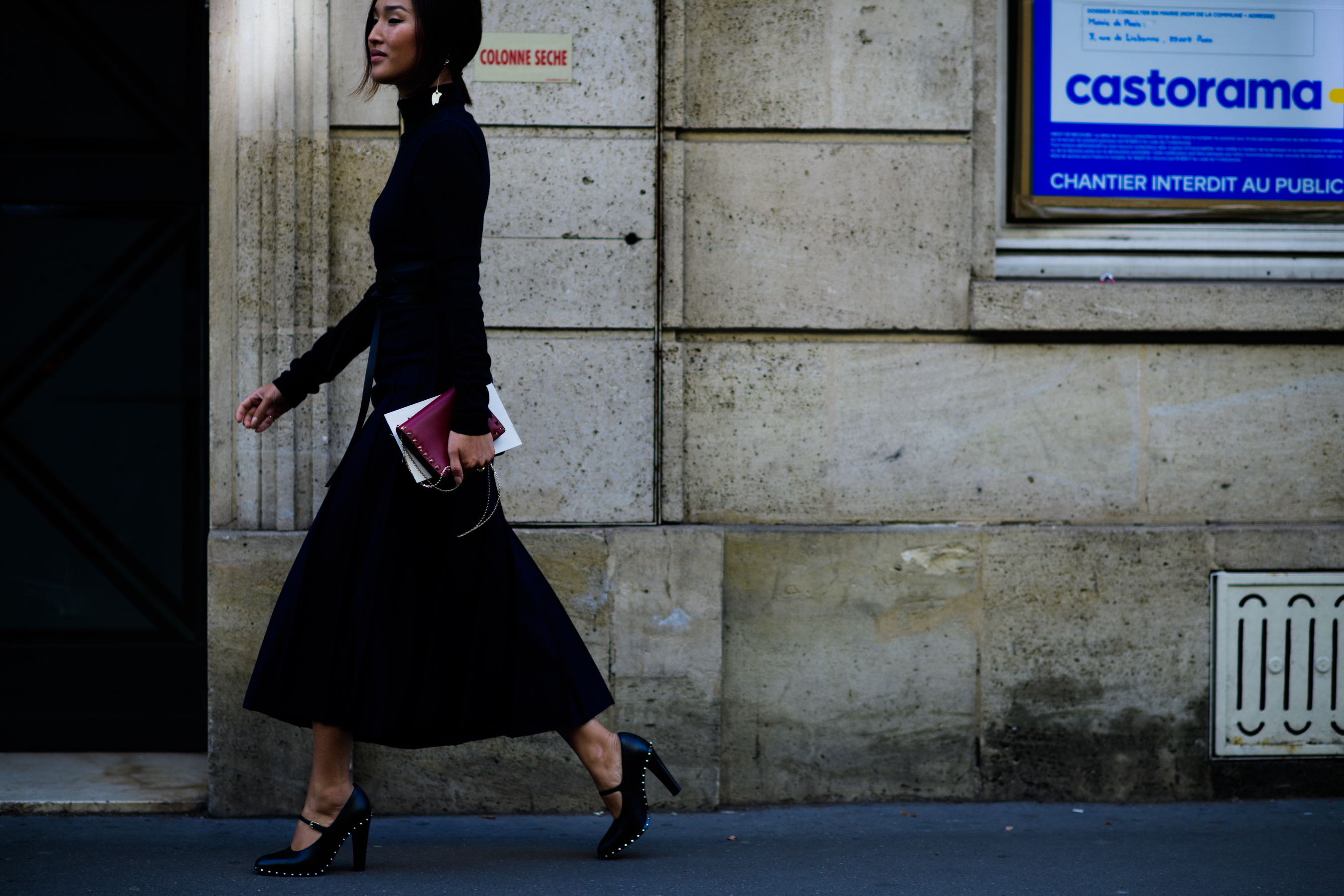 Blogger wearing black outfit with gold details