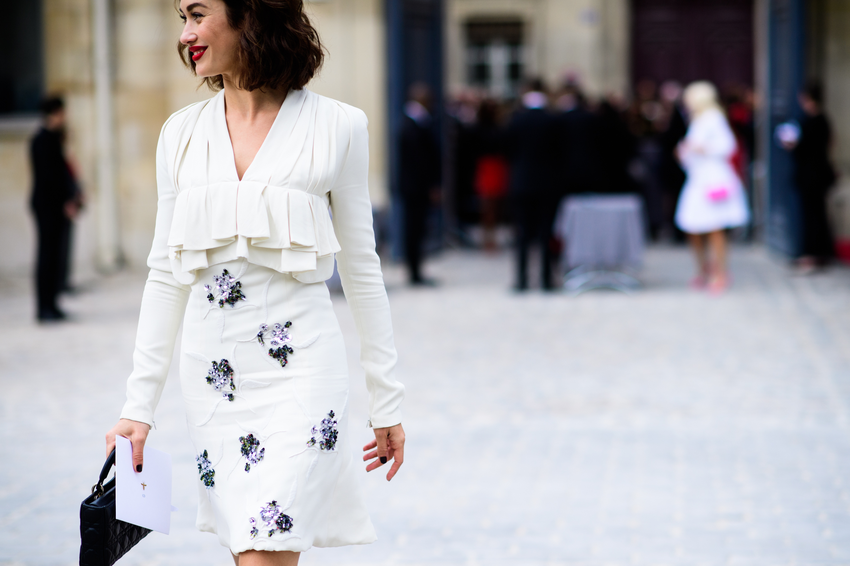 French actress wearing white bead detail outfit