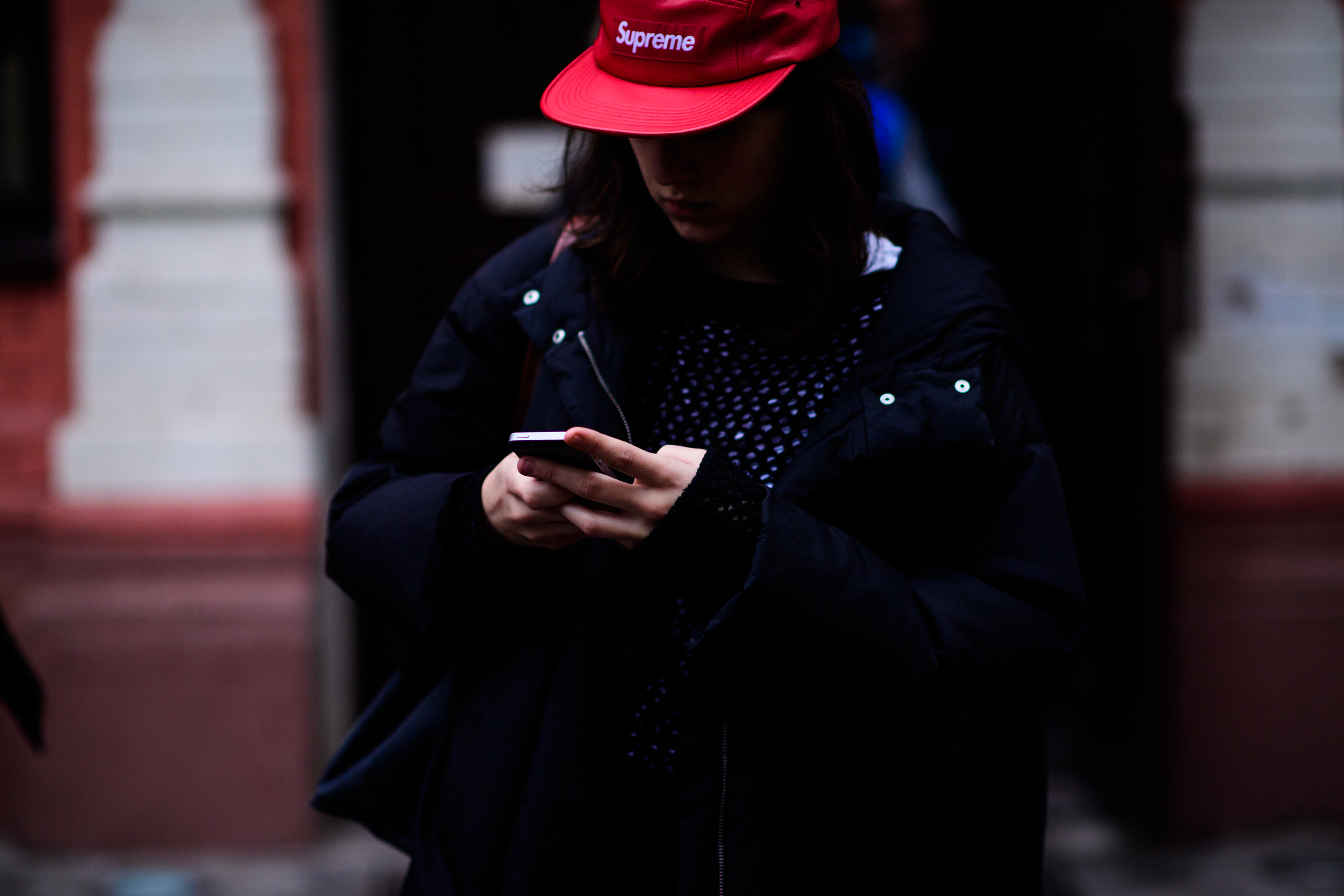 Girl wearing red Supreme hat