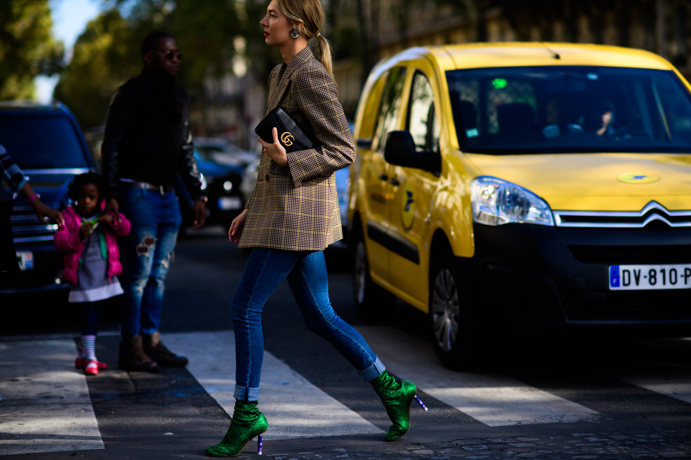 Woman crossing road with Gucci bag