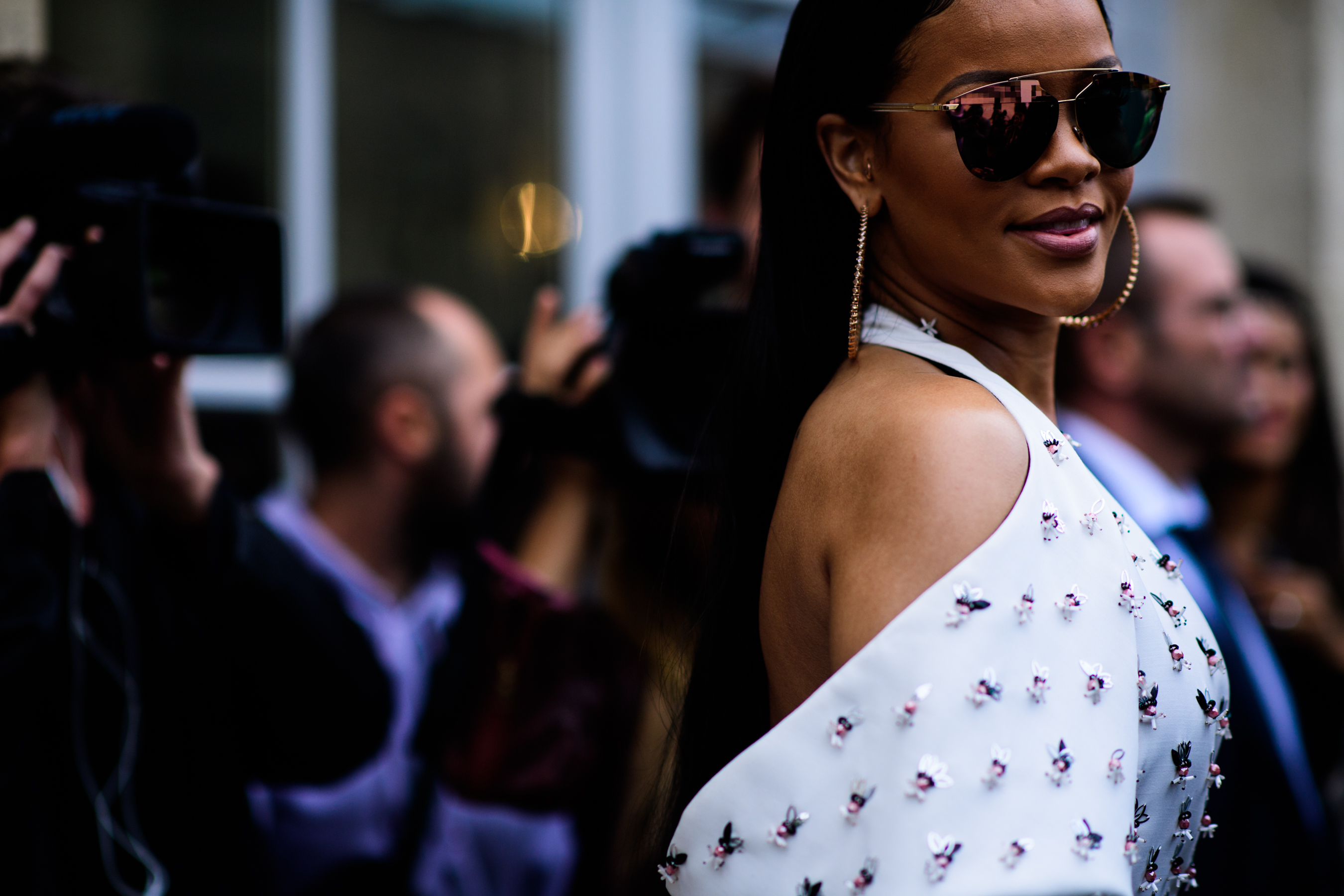 Barbadian musician wearing gold sunglasses and hoop earrings