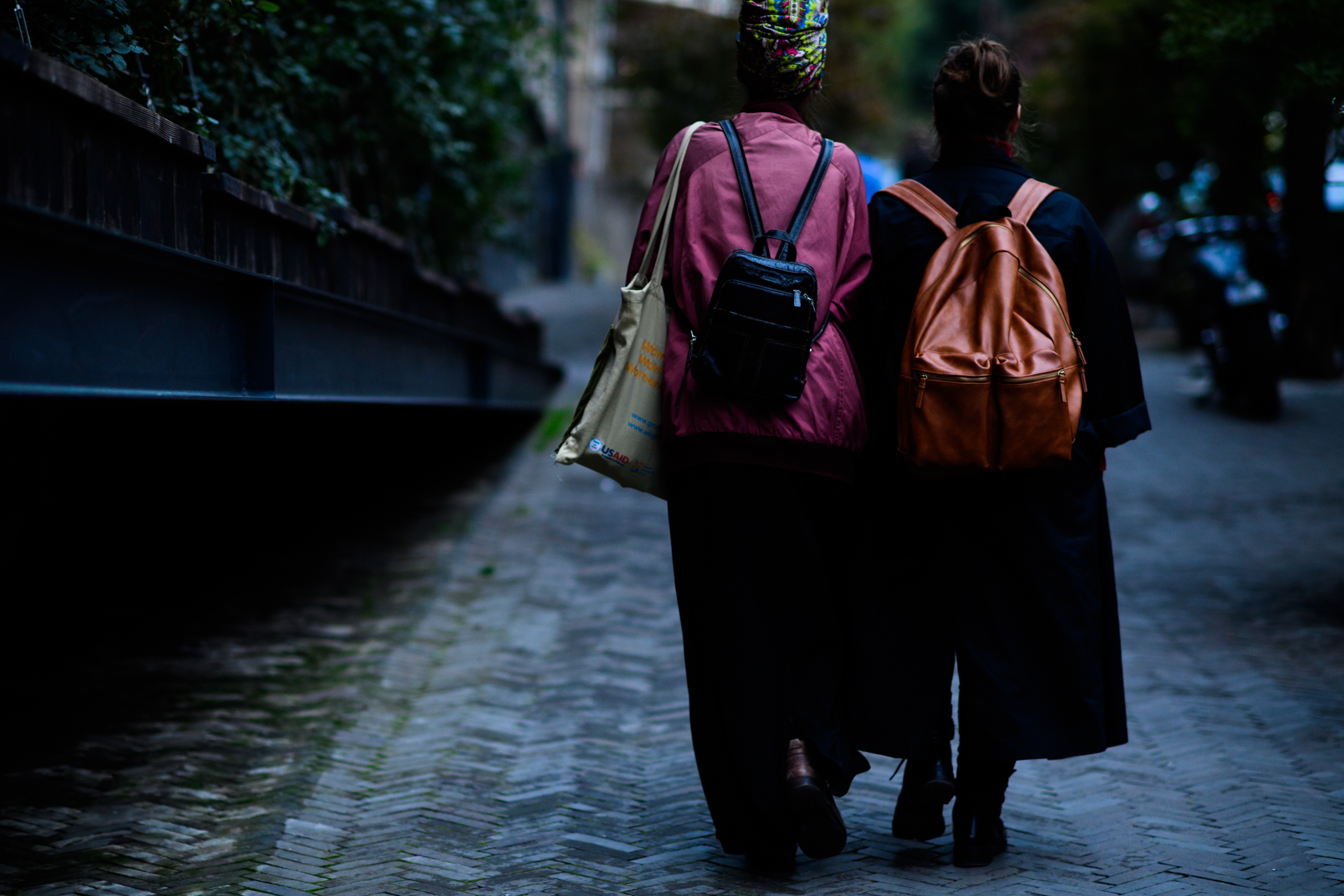 Two girls wearing backpacks