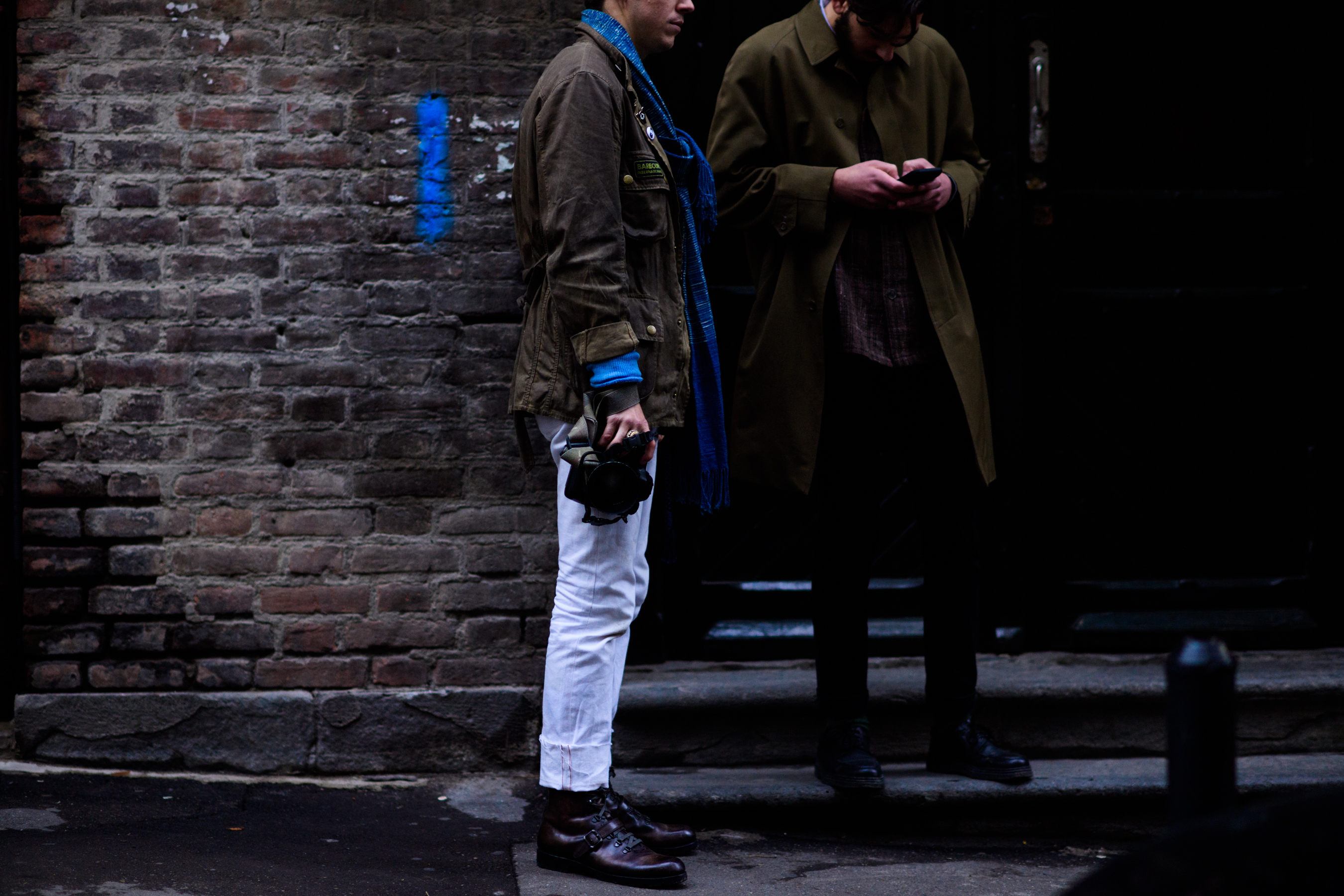 Two men wearing brown jackets