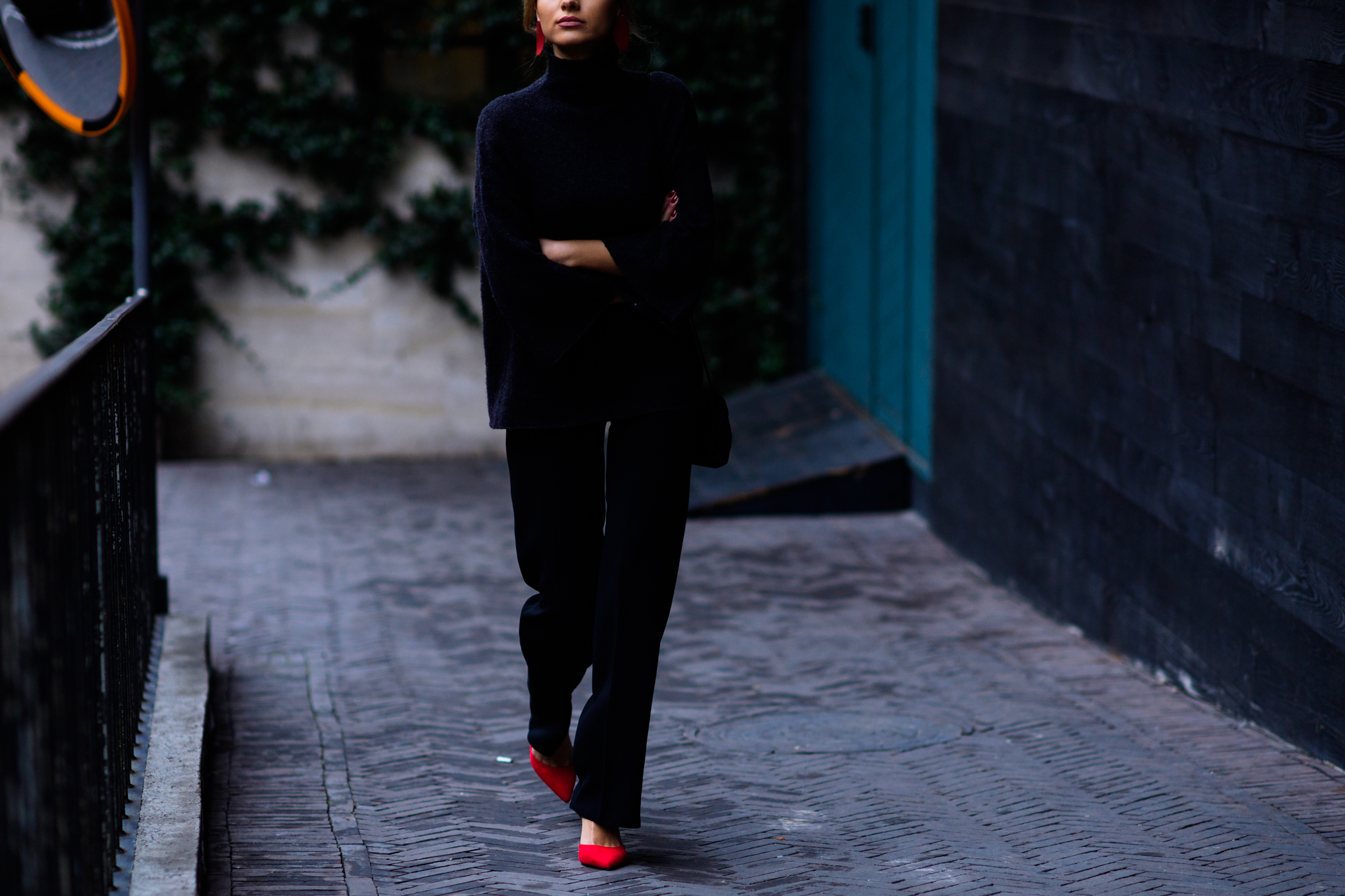 Woman wearing red shoes and earring