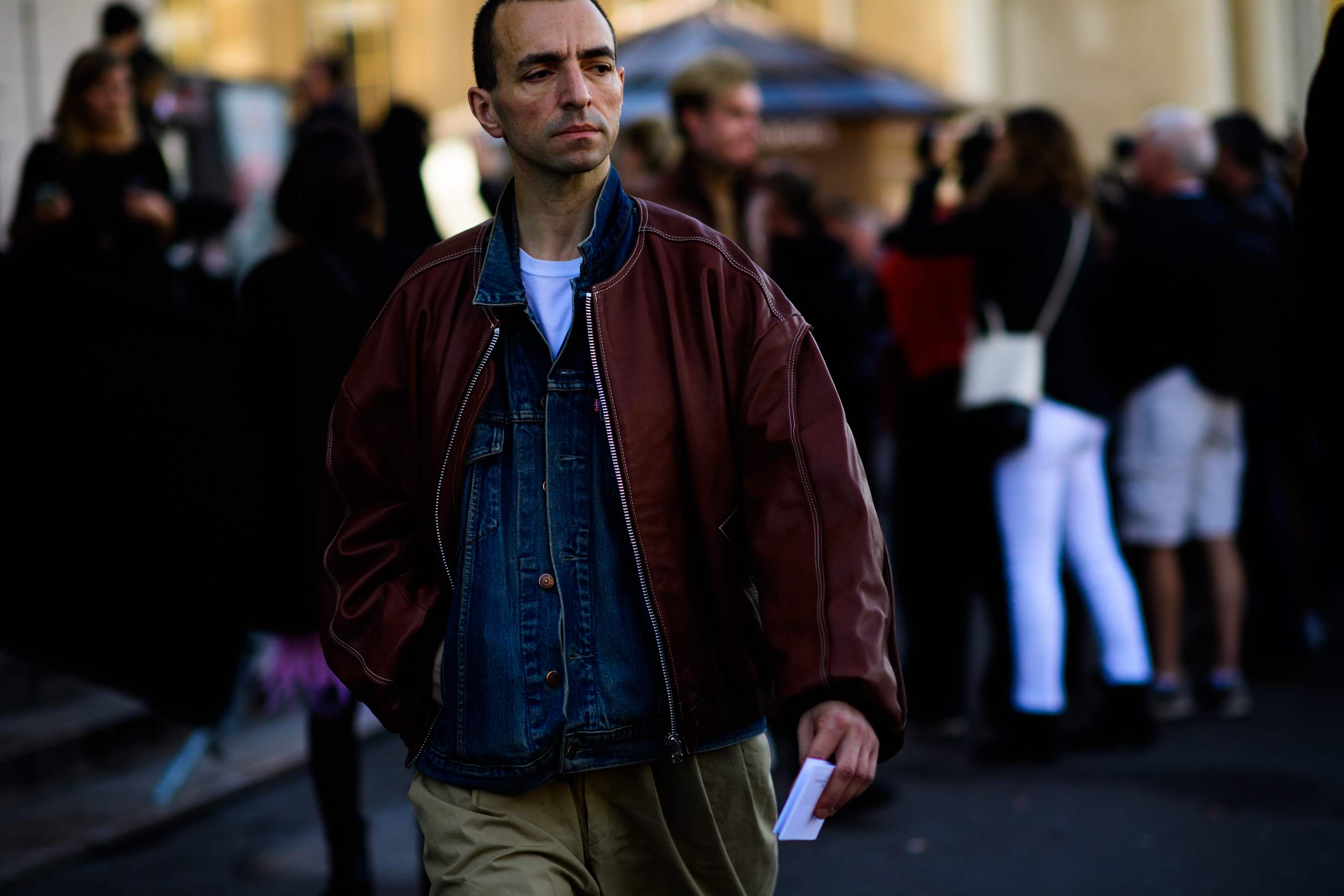 Man wearing brown leather jacket over denim