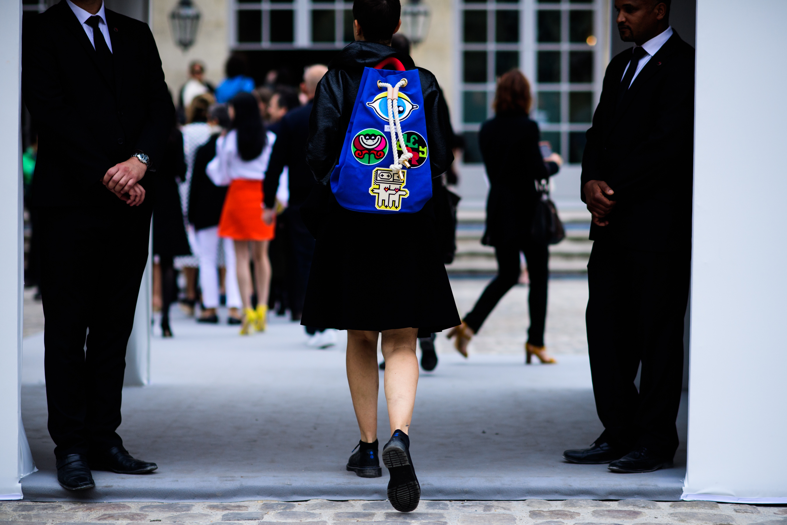 French woman wearing blue backpack