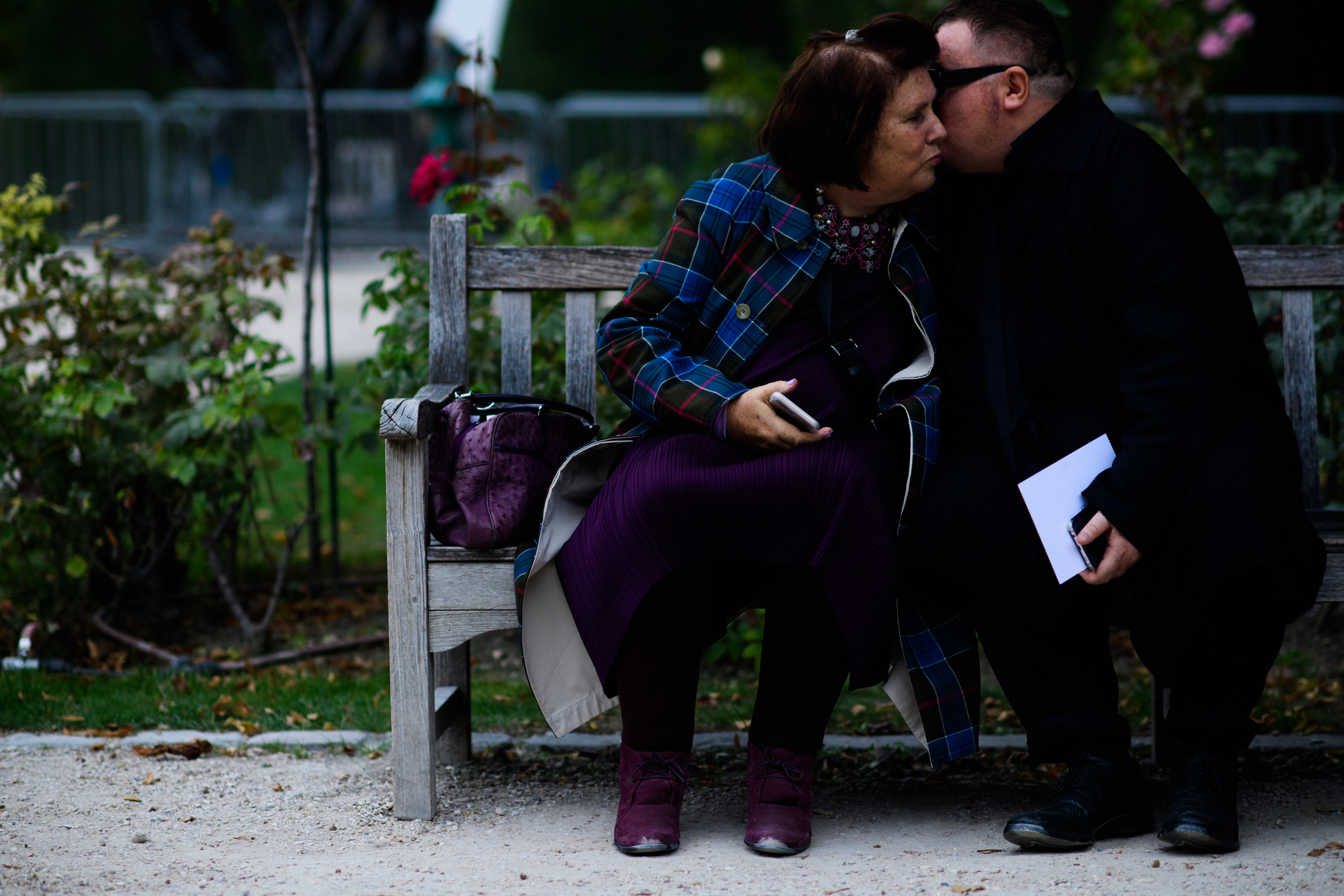 Couple sat on bench talking closely