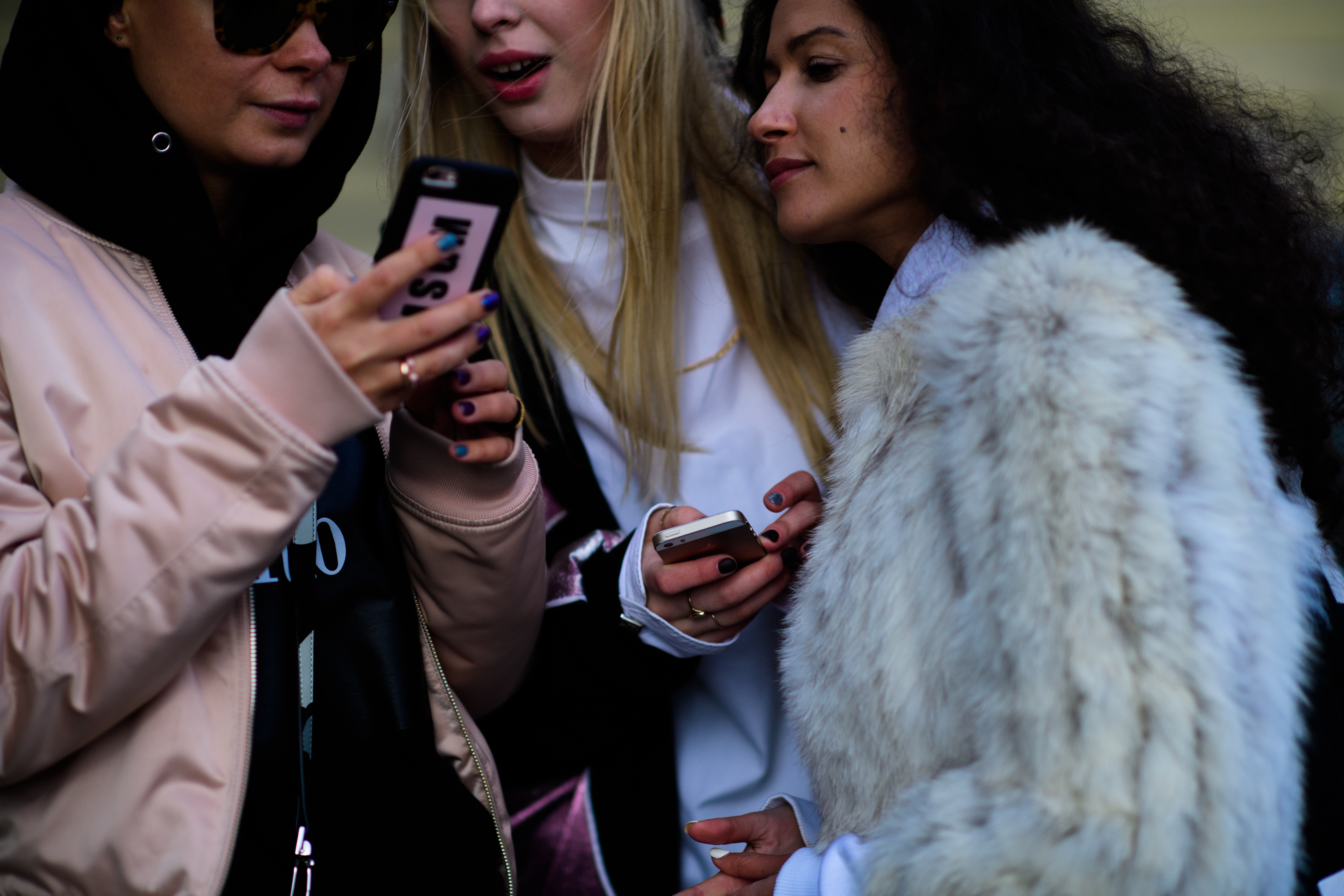 Three Russian girls on their phone