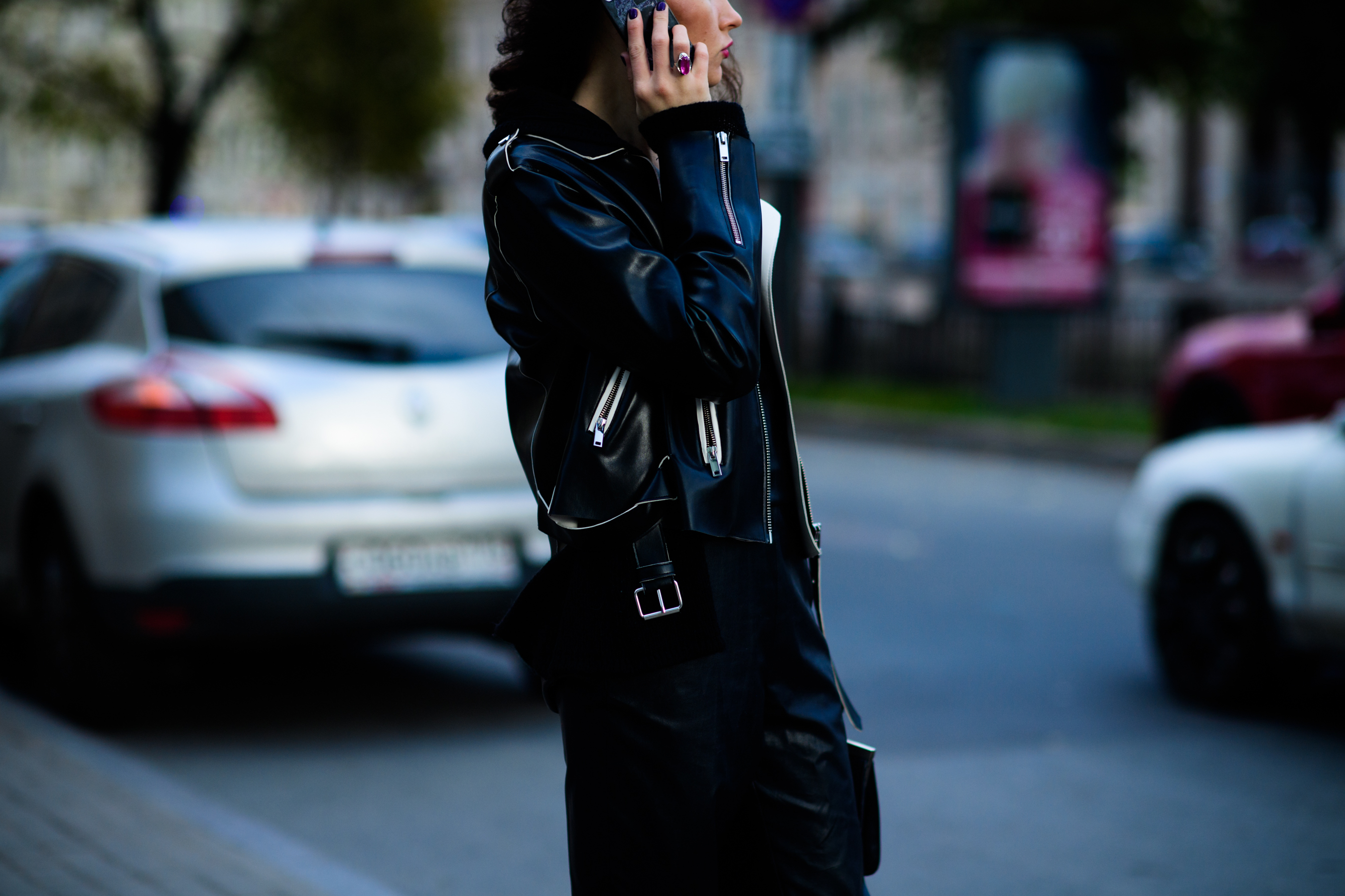 Girl wearing leather jacket with zips