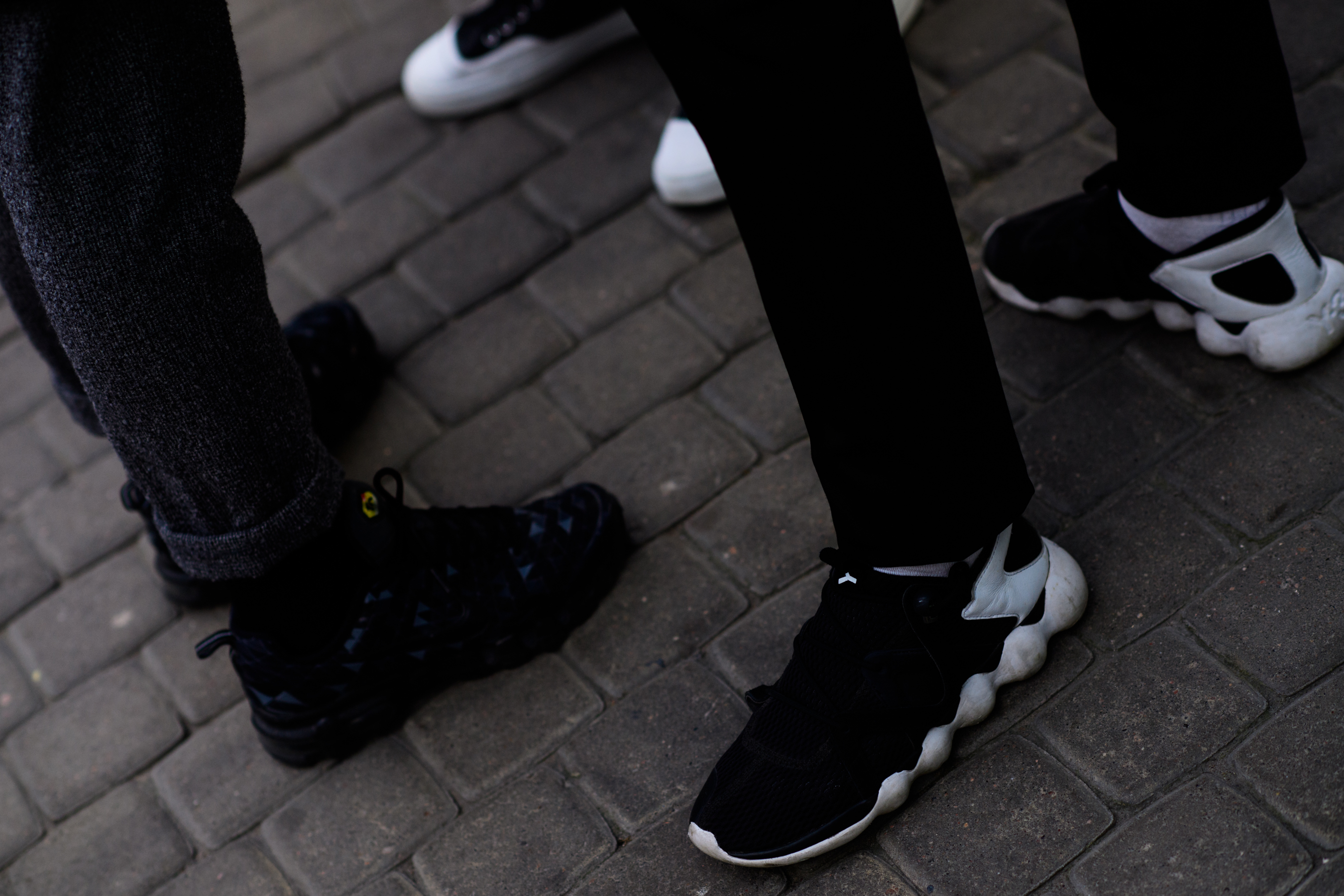 Group of men wearing black sneakers