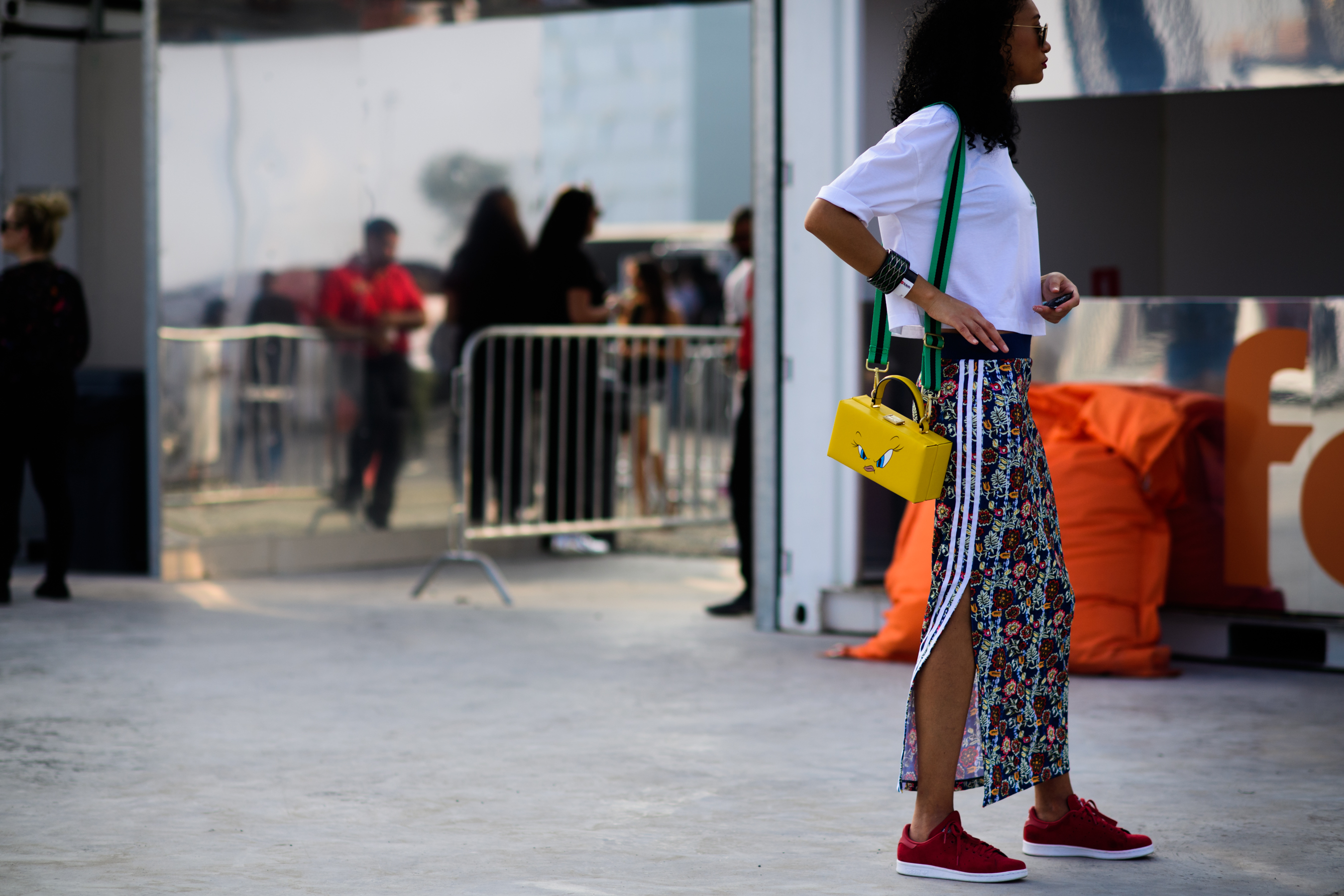 Woman wearing yellow tweety bag
