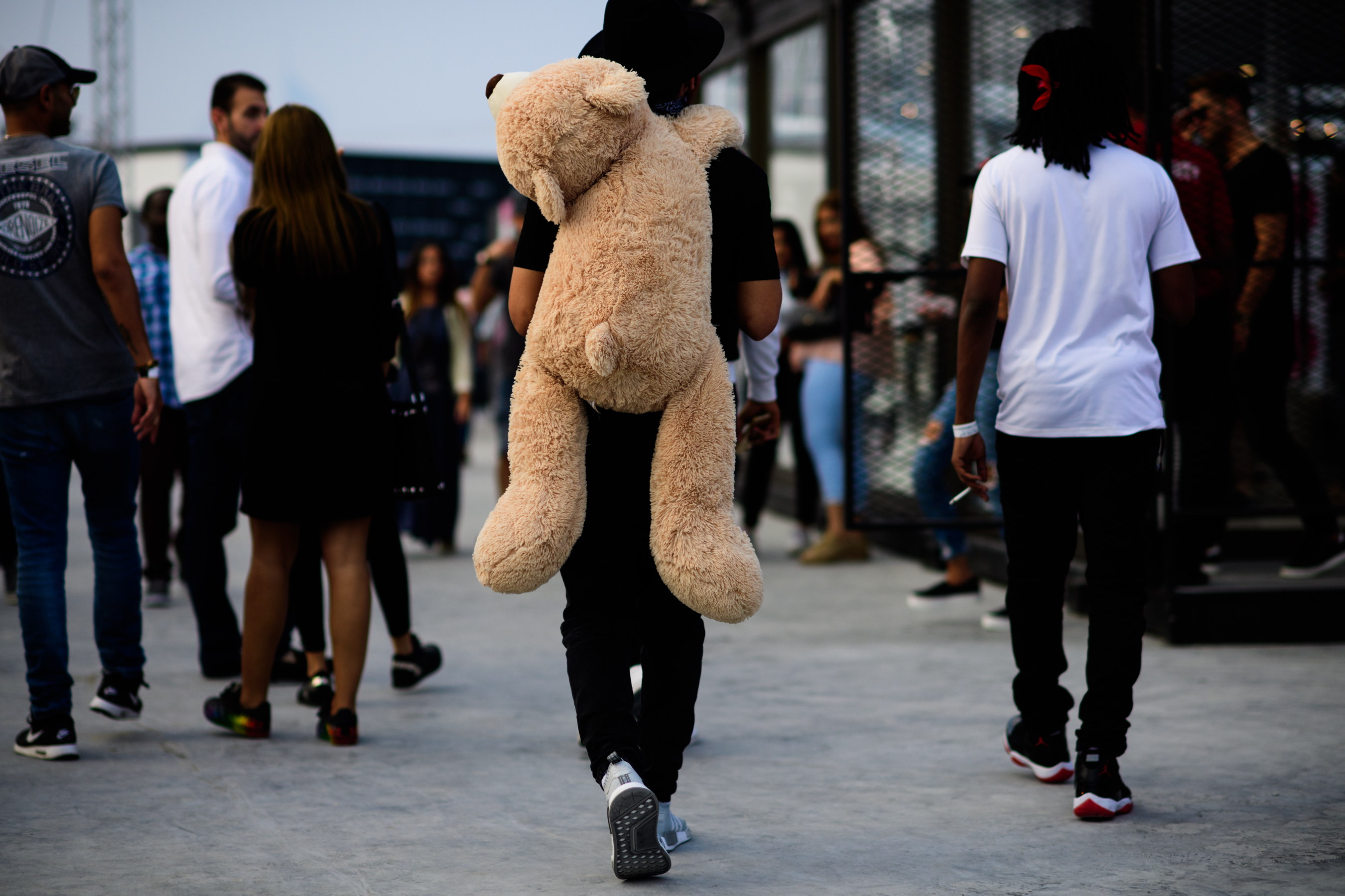 Man with big teddy bear on the back