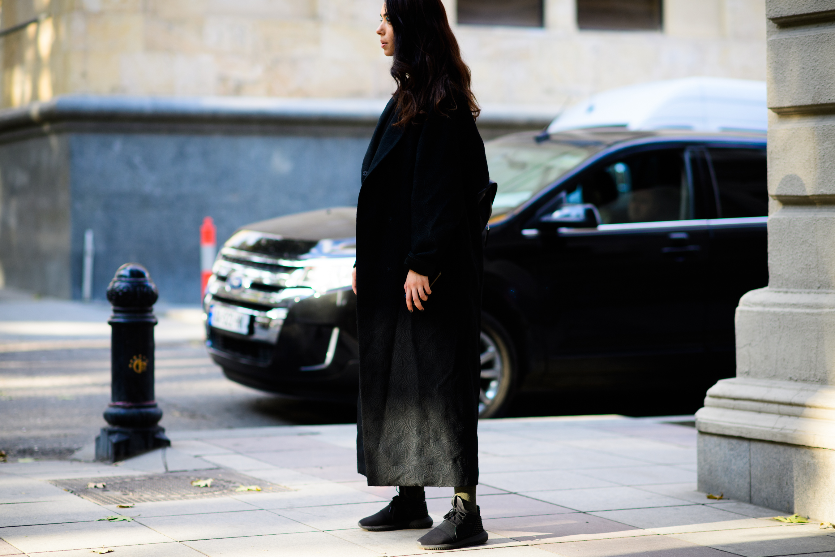 Model wearing long black coat