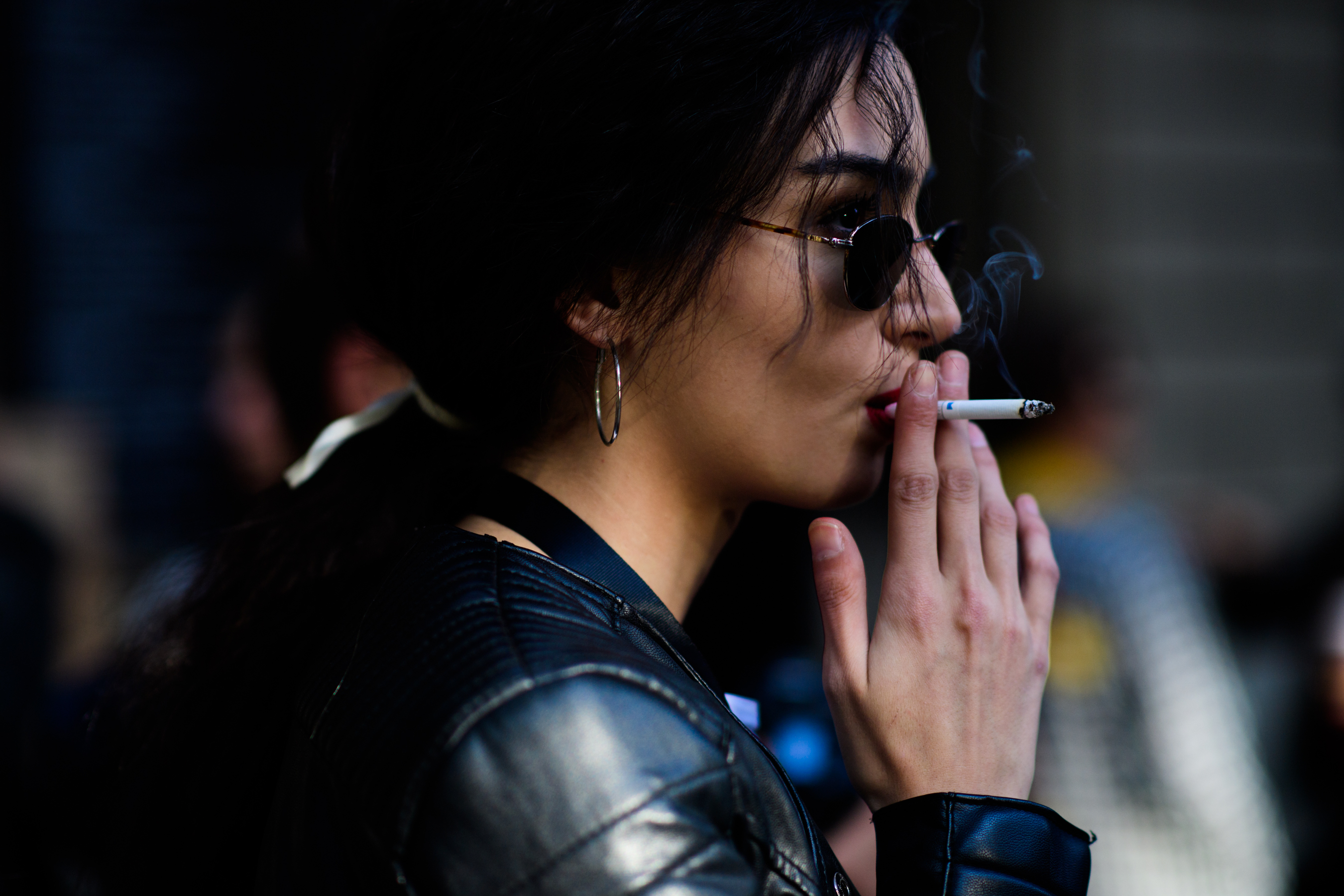 Woman in dark glasses smoking